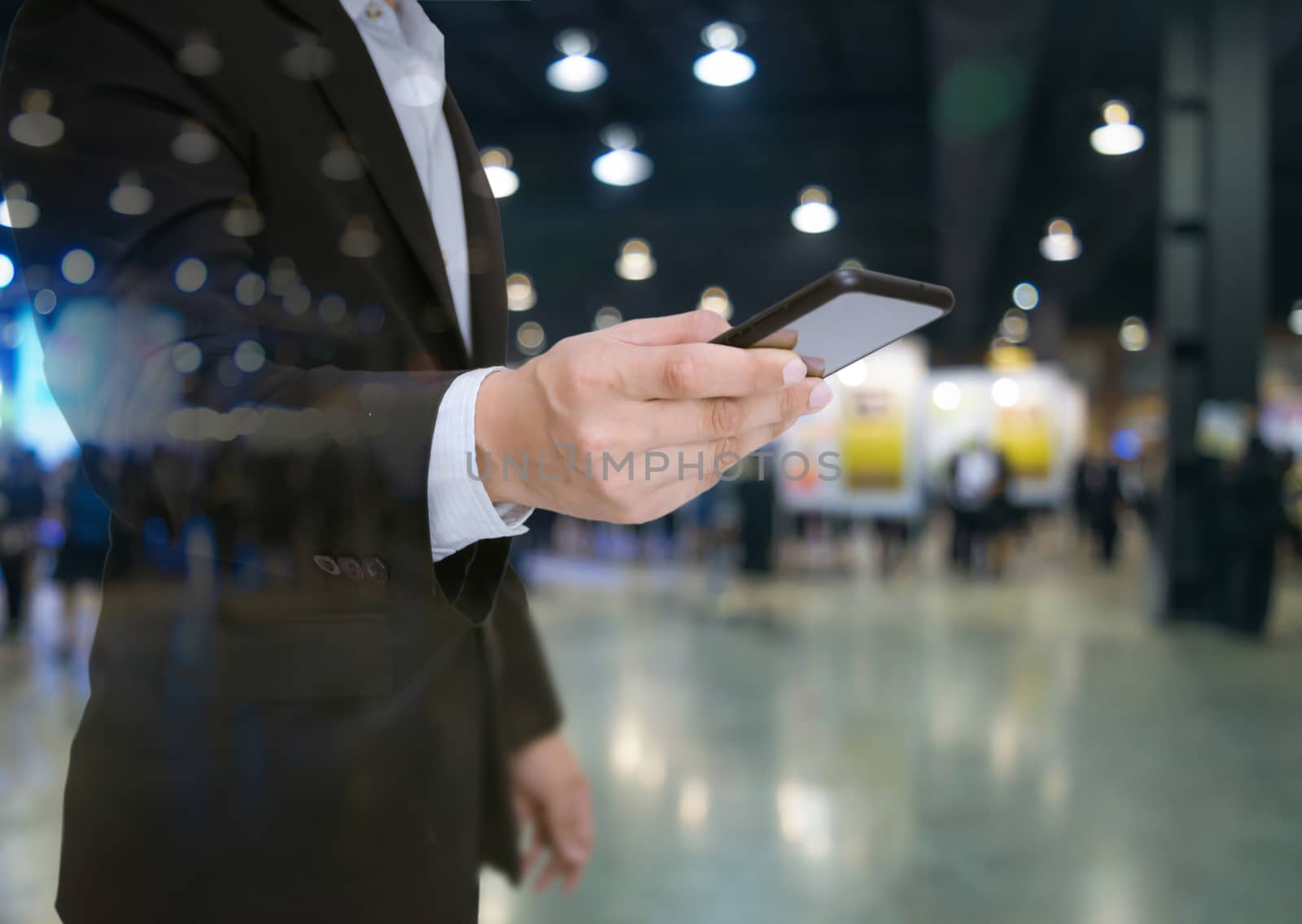 Double exposure businessman wearing a suit hold a smartphone