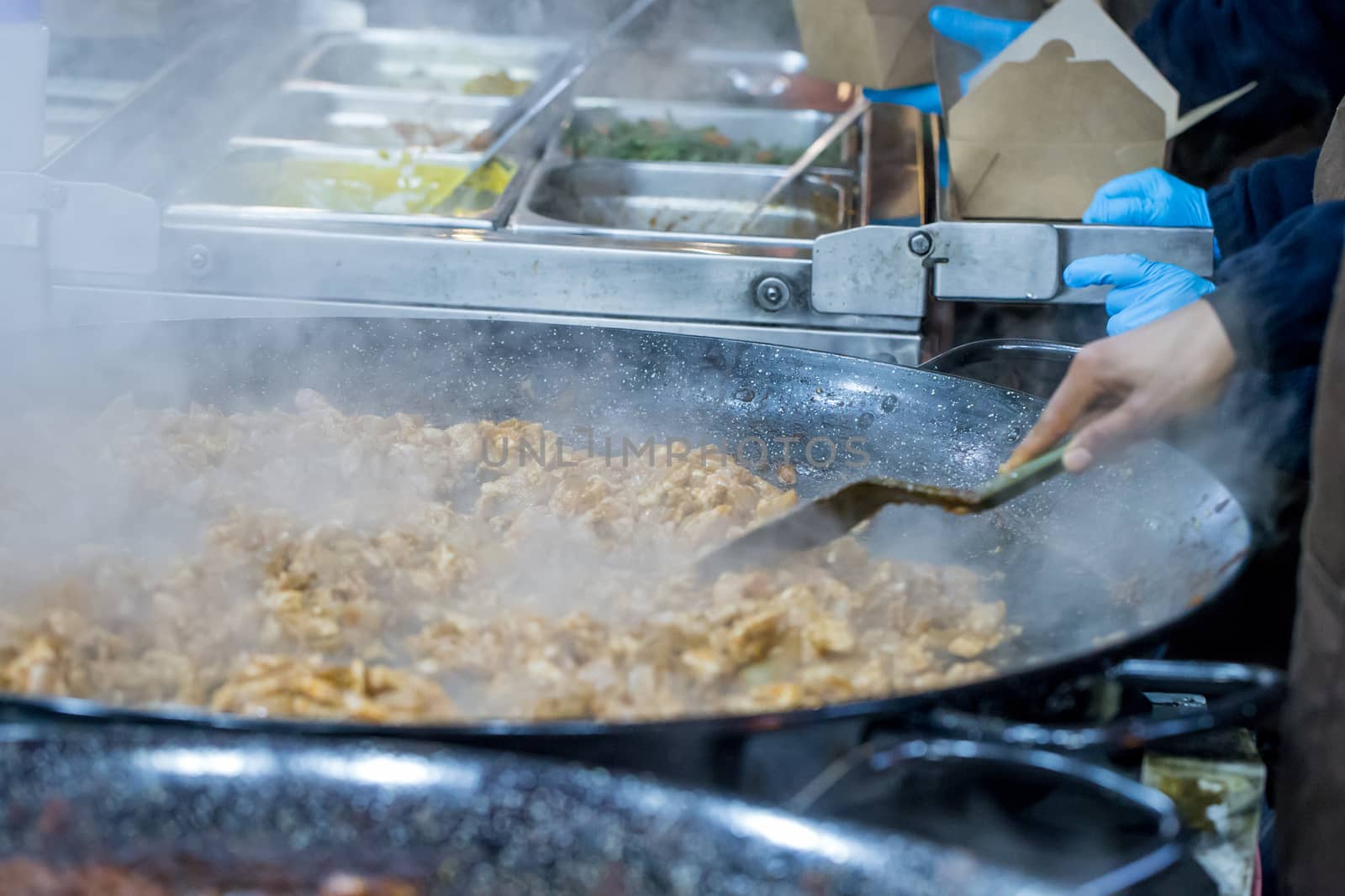 Cropped shot of hot food being prepared on a market stall in London