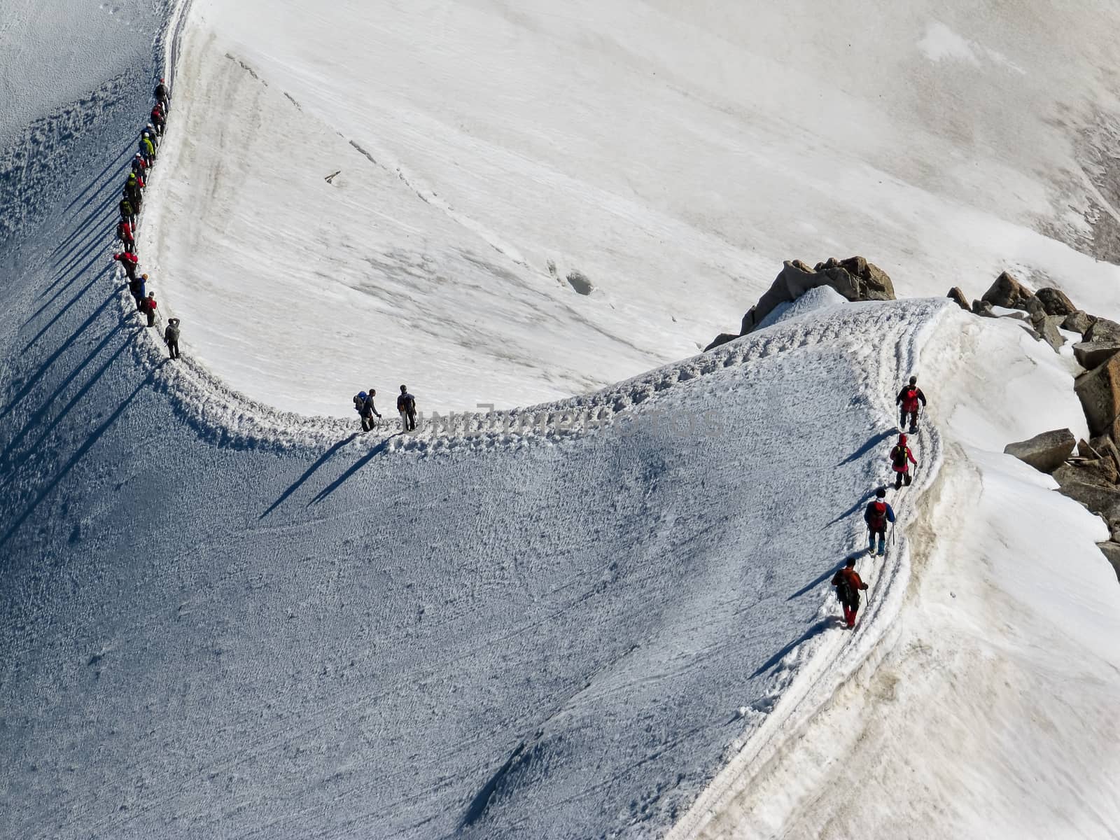Trekkers on Aiguille Du Midi, in the french alps  by magicbones