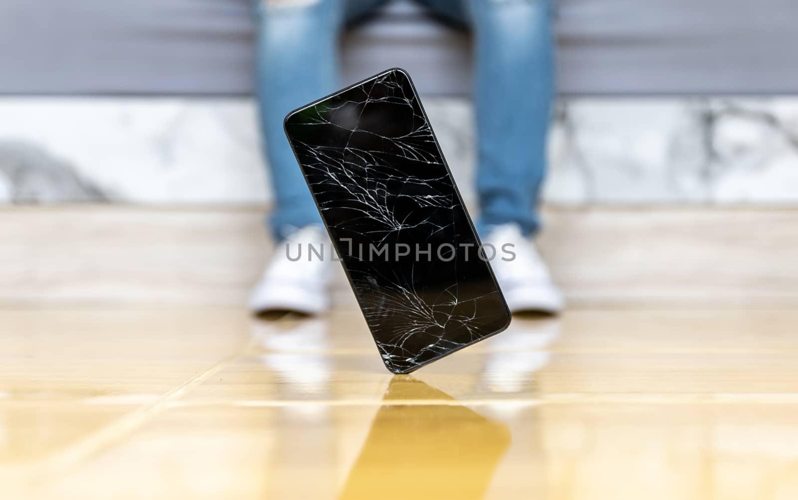People fall smartphone on the floor broken screen