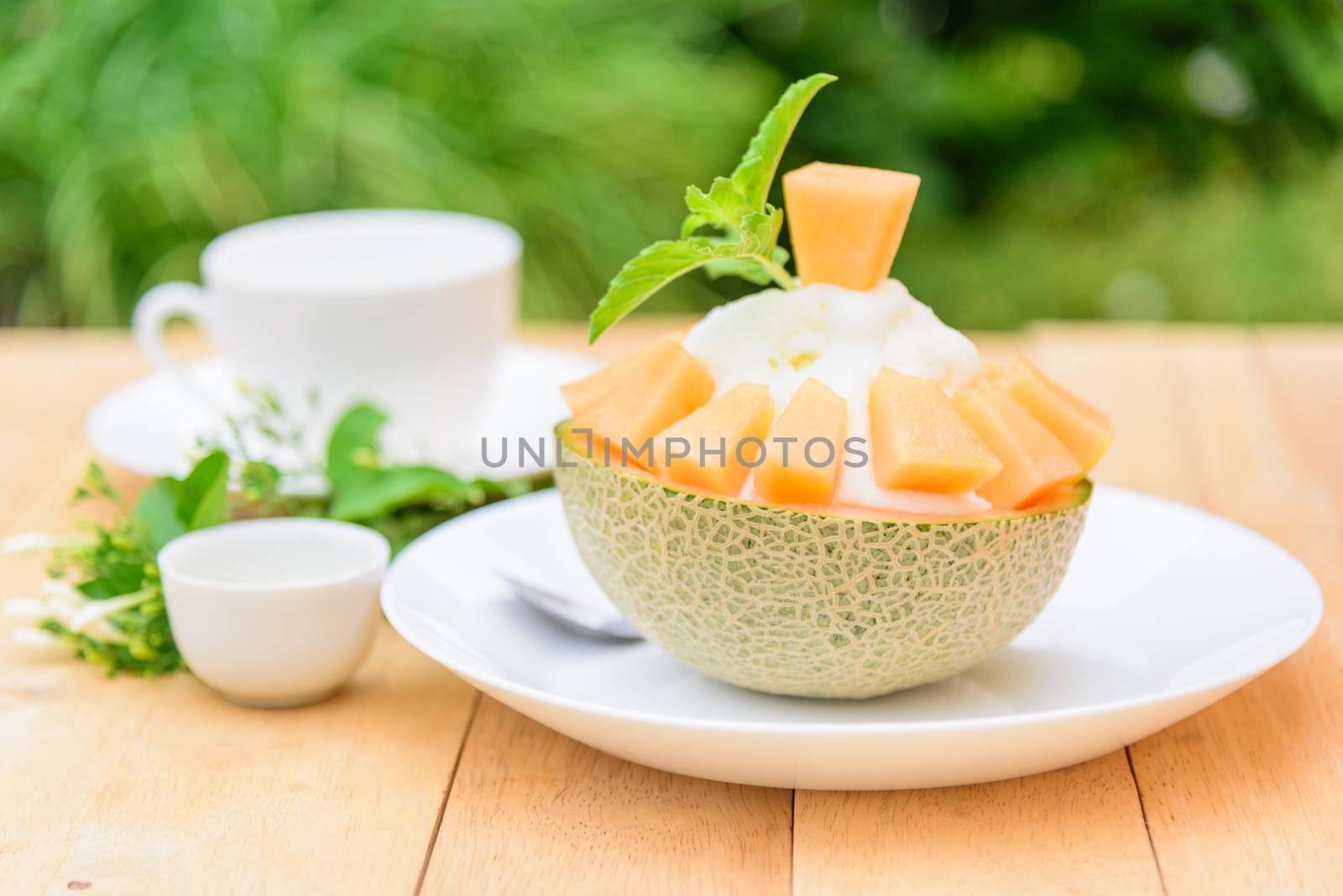 Melon Bingsu with Sweetened Condensed Milk on wood table by rukawajung