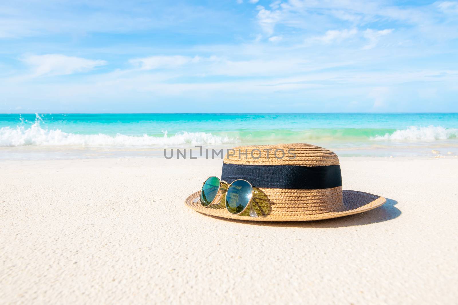 Hats and glasses placed on the beach and sea have a holiday summer relaxing and travel bright sky koh lipe thailand by sompongtom