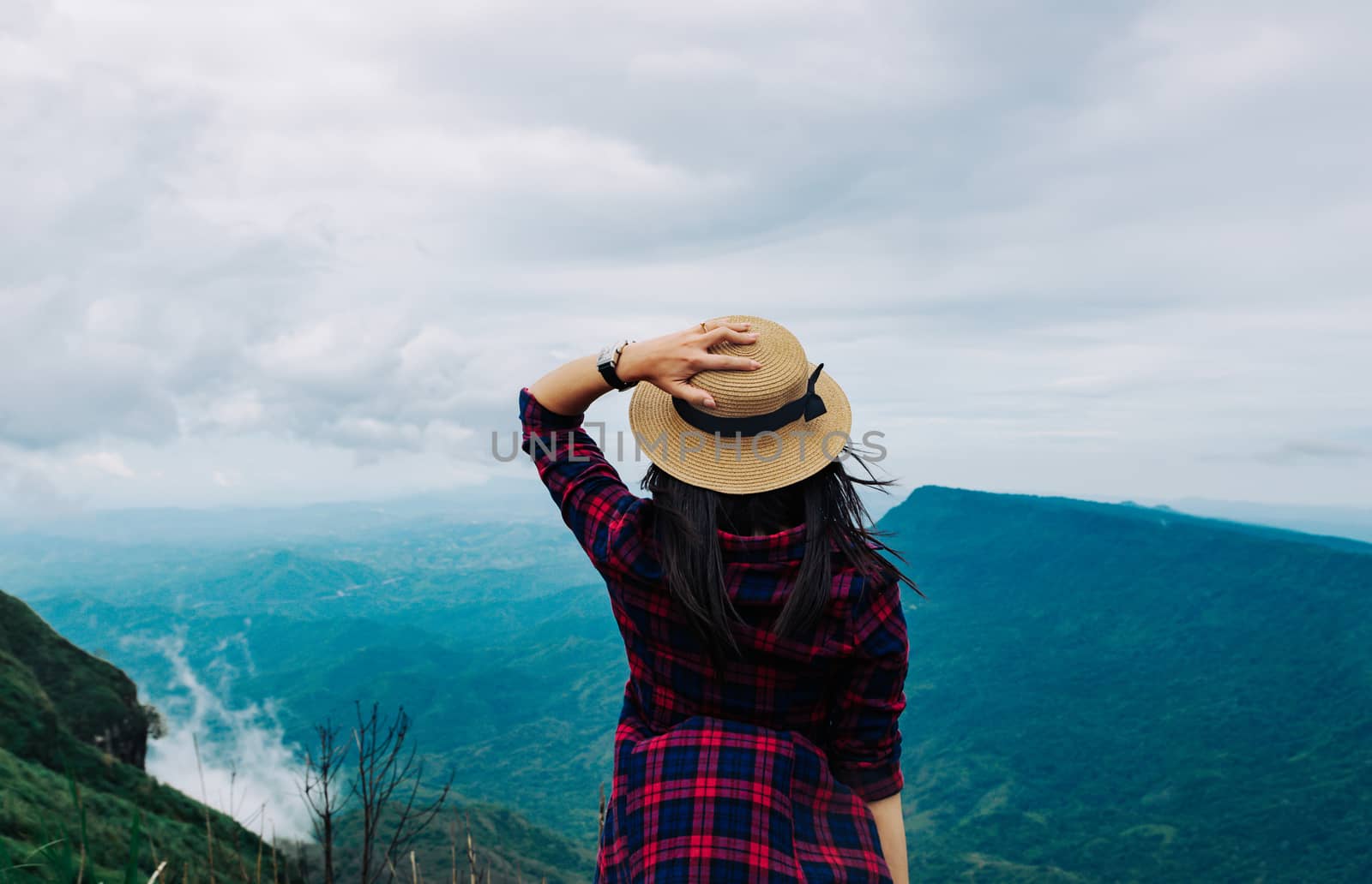 Woman travel rainy season mountain view relax in the holiday