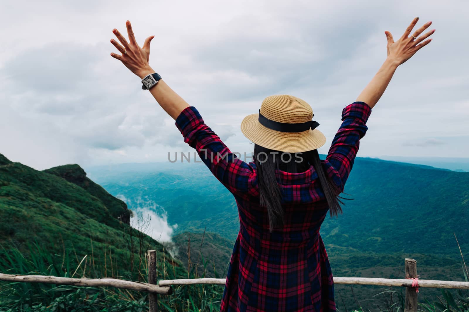 Woman travel rainy season mountain view relax in the holiday by sompongtom