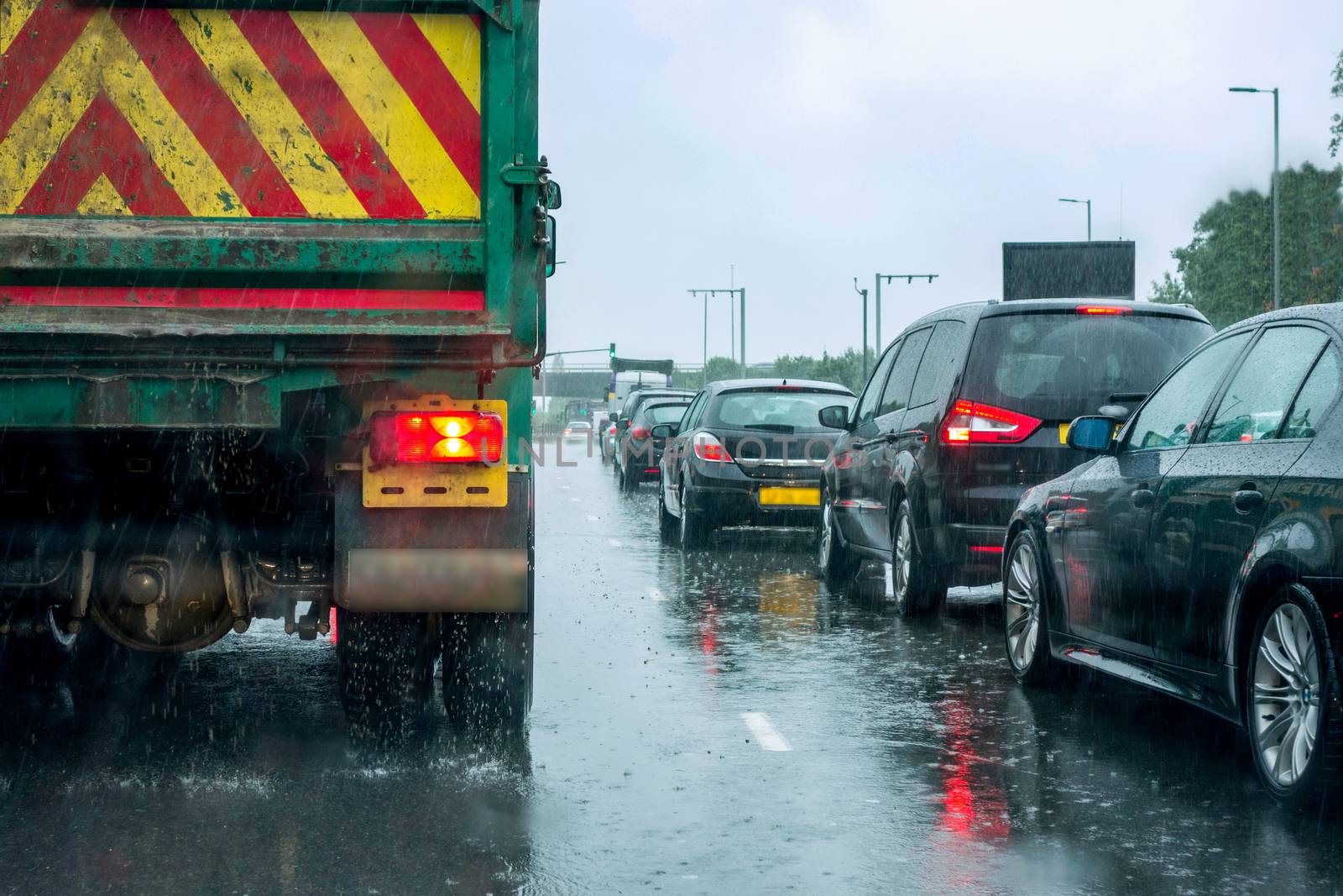 An image of traffic on a London road in heavy rain.