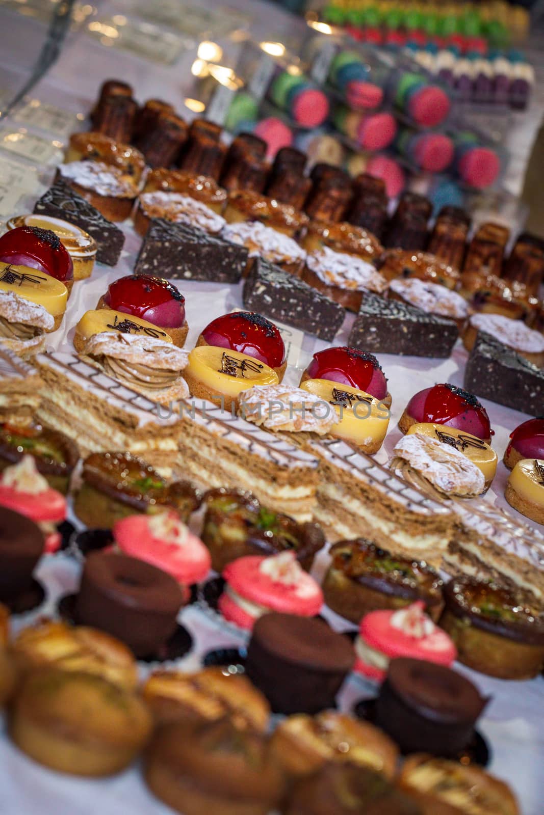 A variety of cakes on display at a market cake stall by magicbones