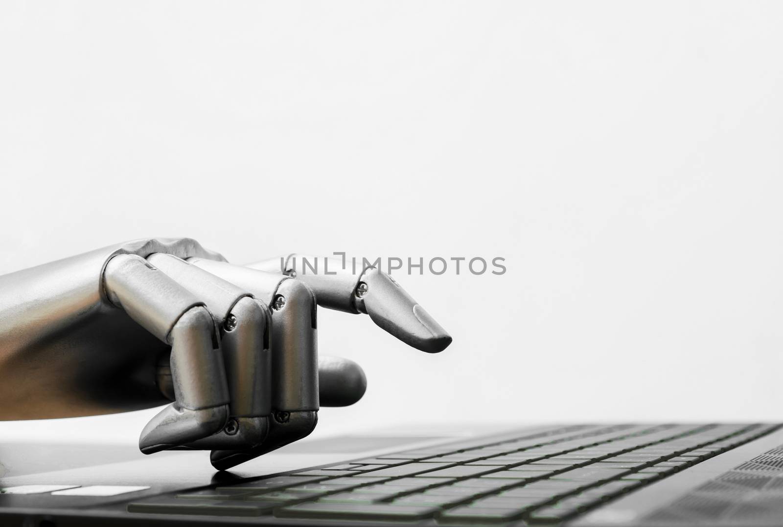 Robot concept or robot hand chatbot pressing computer keyboard enter by sompongtom