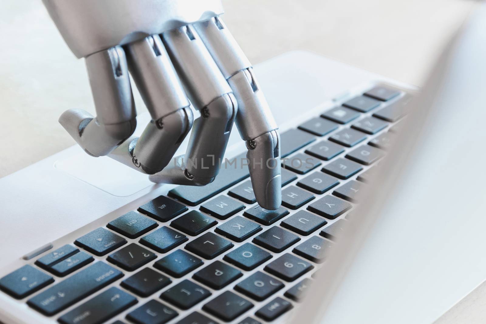 Robot hands and fingers point to laptop button advisor chatbot robotic artificial intelligence concept