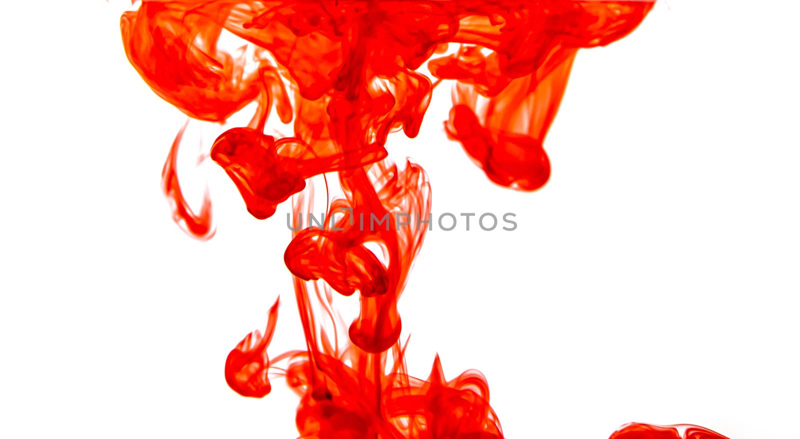 The red color paint splash drips into clear water. by sompongtom