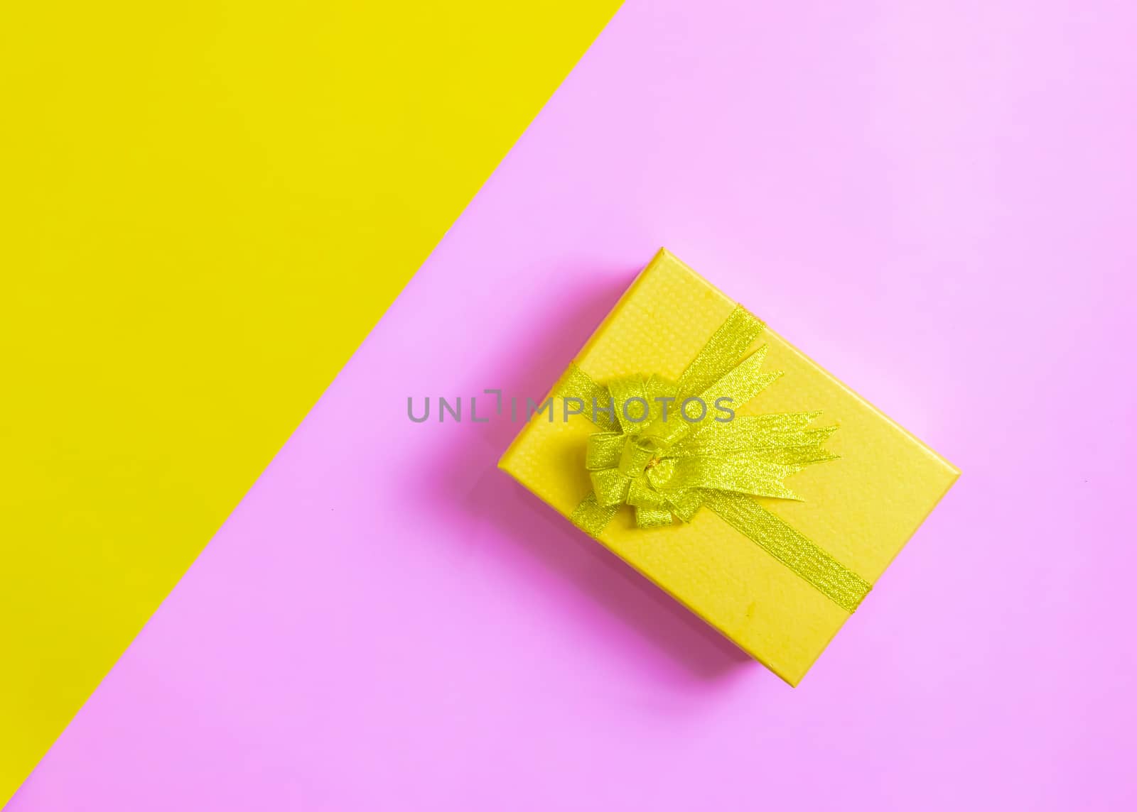 Gift box on festival day yellow and pink background by sompongtom