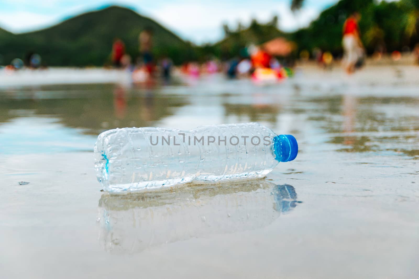 Plastic bottle garbage on the beach Human waste dumping by sompongtom