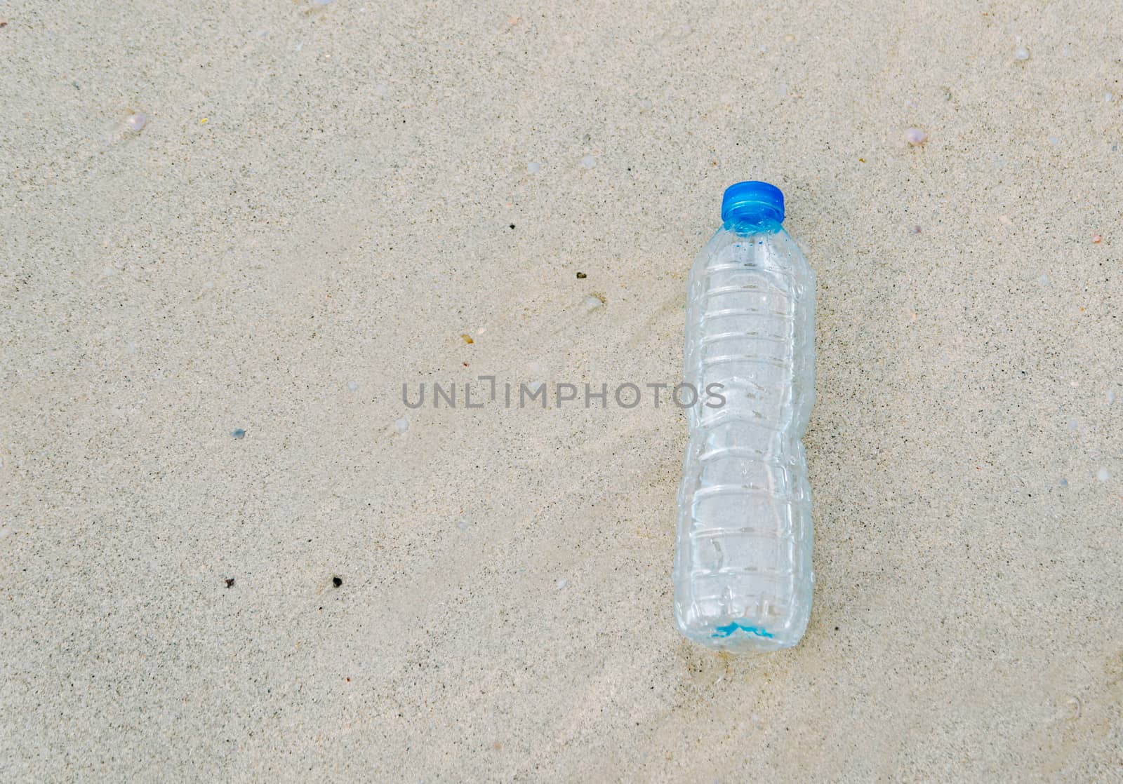 Plastic bottle garbage on the beach Human waste dumping by sompongtom