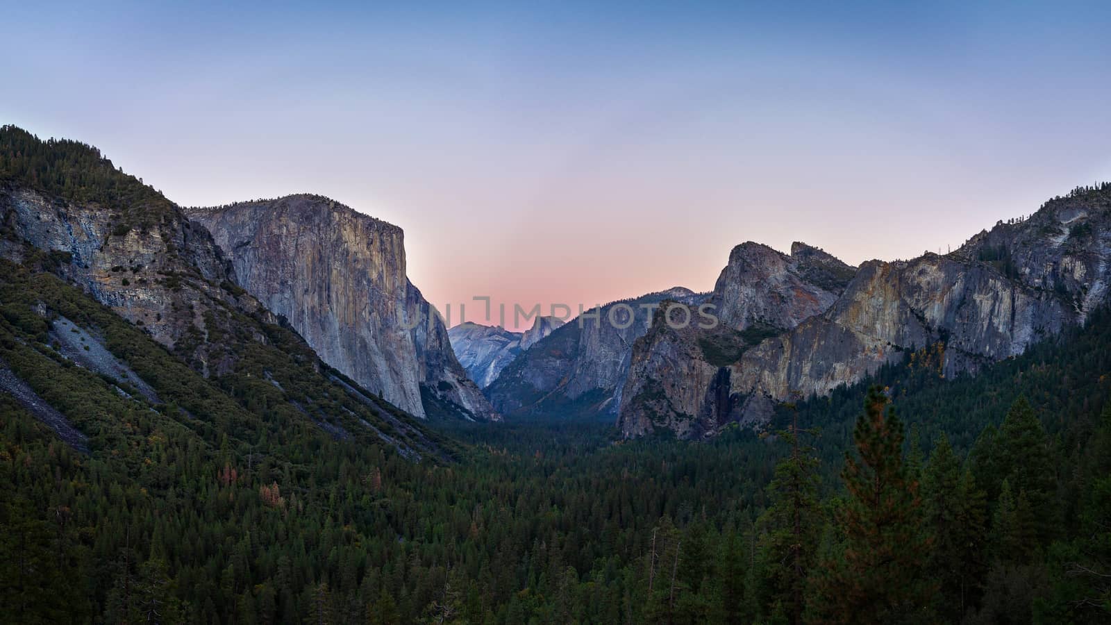 Yosemite valley nation park during sunset view from tunnel view on twilight time. Yosemite nation park, California, USA. Panoramic image.