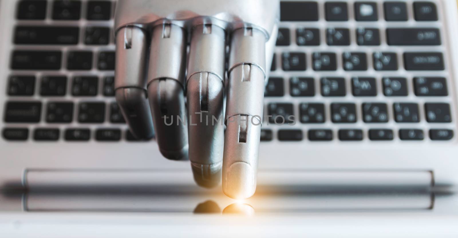 Robot hands and fingers point to laptop button advisor chatbot robotic artificial intelligence concept with light effect by sompongtom