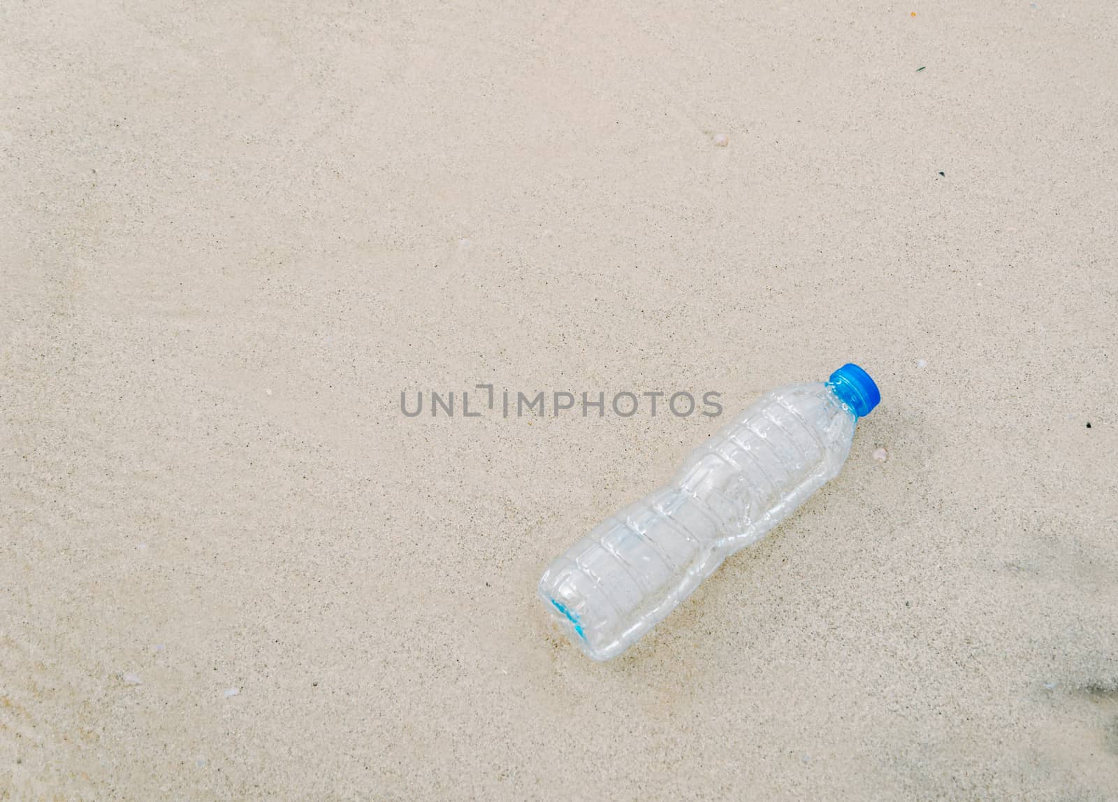 Plastic bottle garbage on the beach Human waste dumping by sompongtom