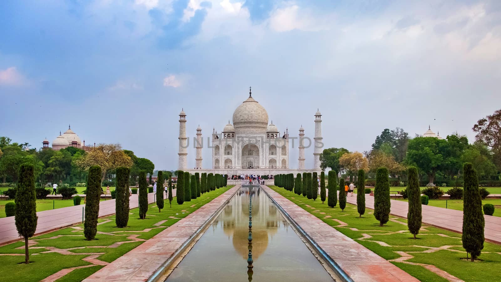 Taj Mahal front view reflected on the reflection pool, an ivory-white marble mausoleum on the south bank of the Yamuna river in Agra, Uttar Pradesh, India. One of the seven wonders of the world.