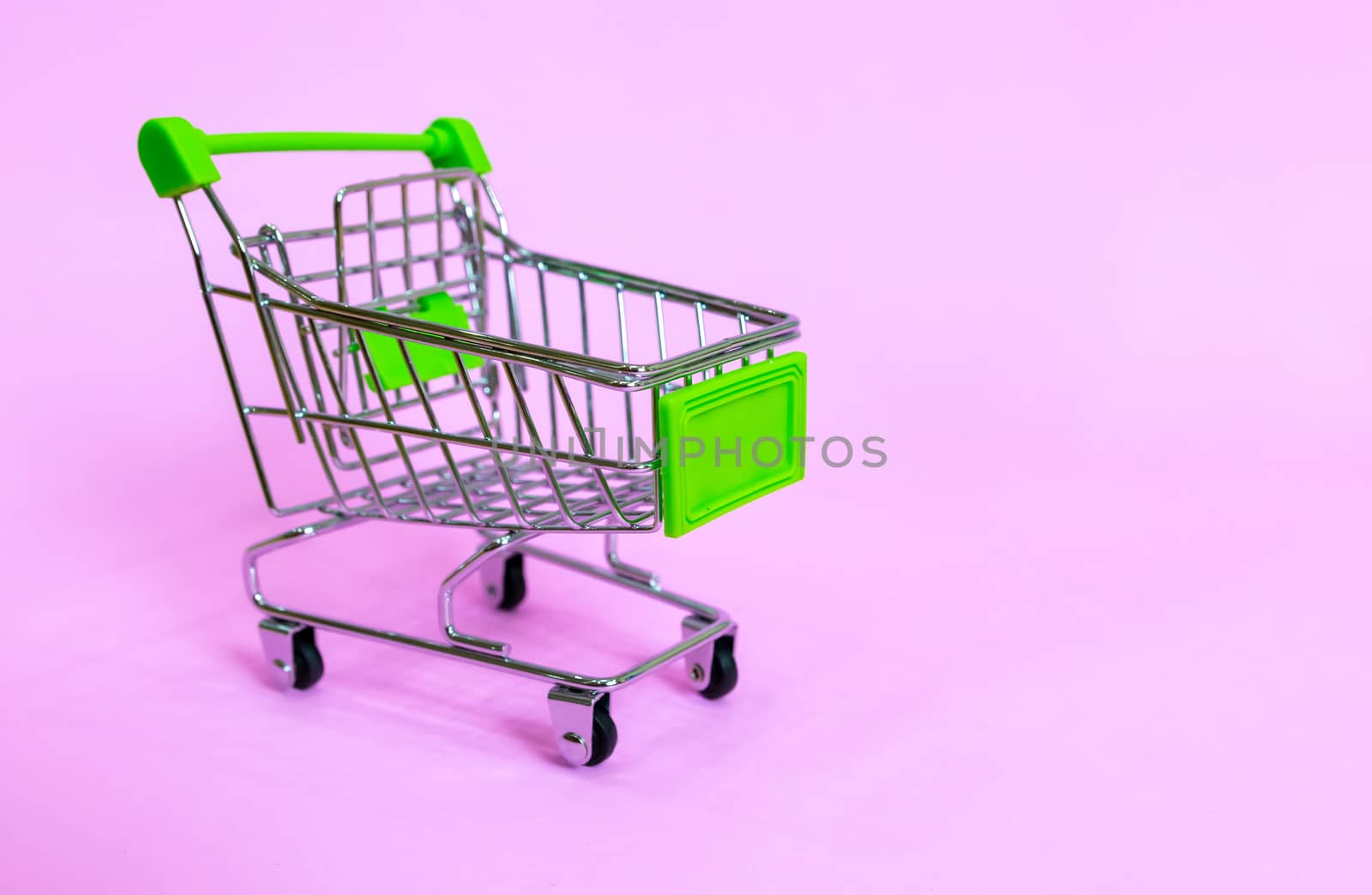 Shopping cart in the supermarket on a purple background by sompongtom