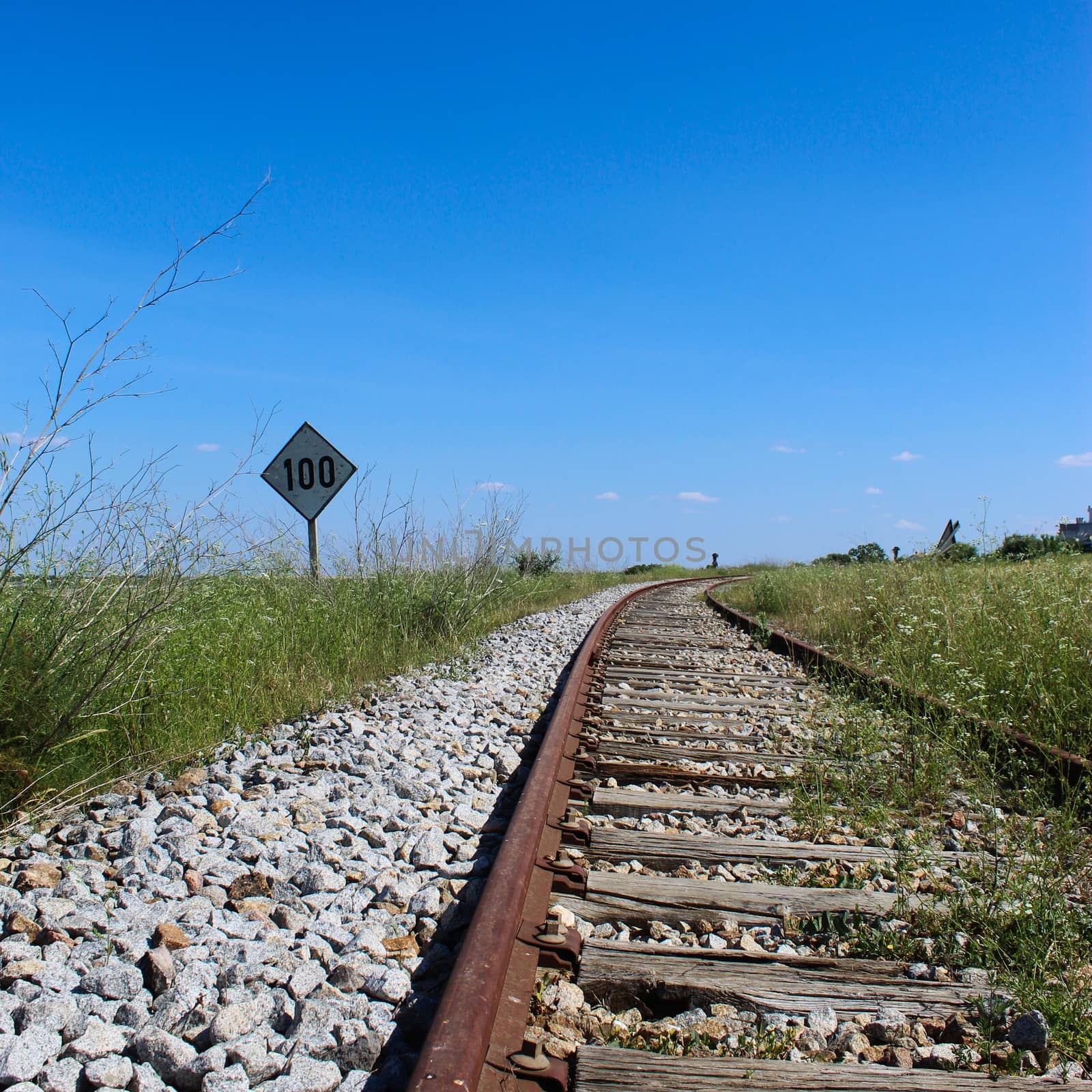An old railway with a sign on the side that says 100. Railway in Beja, Portugal.