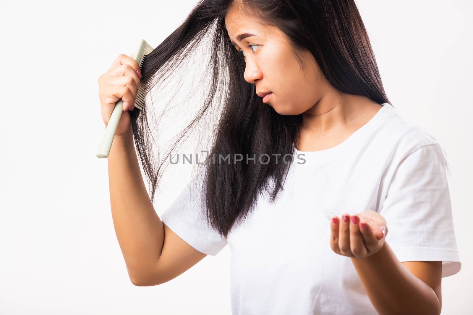 Woman weak hair problem her use comb hairbrush brush her hair an by Sorapop