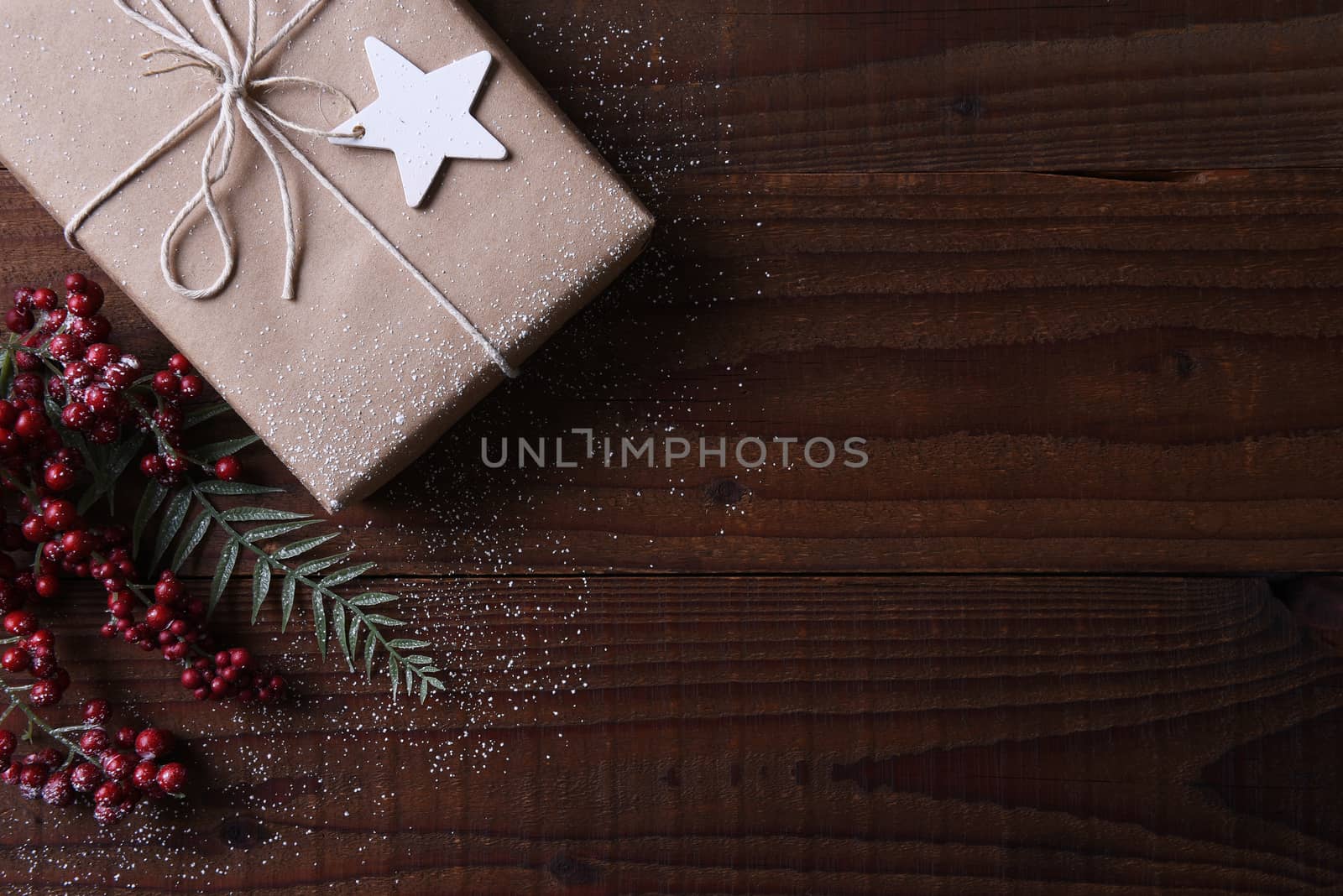 Top view of a plain brown paper Christmas present tied with string and a star shaped gift tag, Horizontal format with copy space.