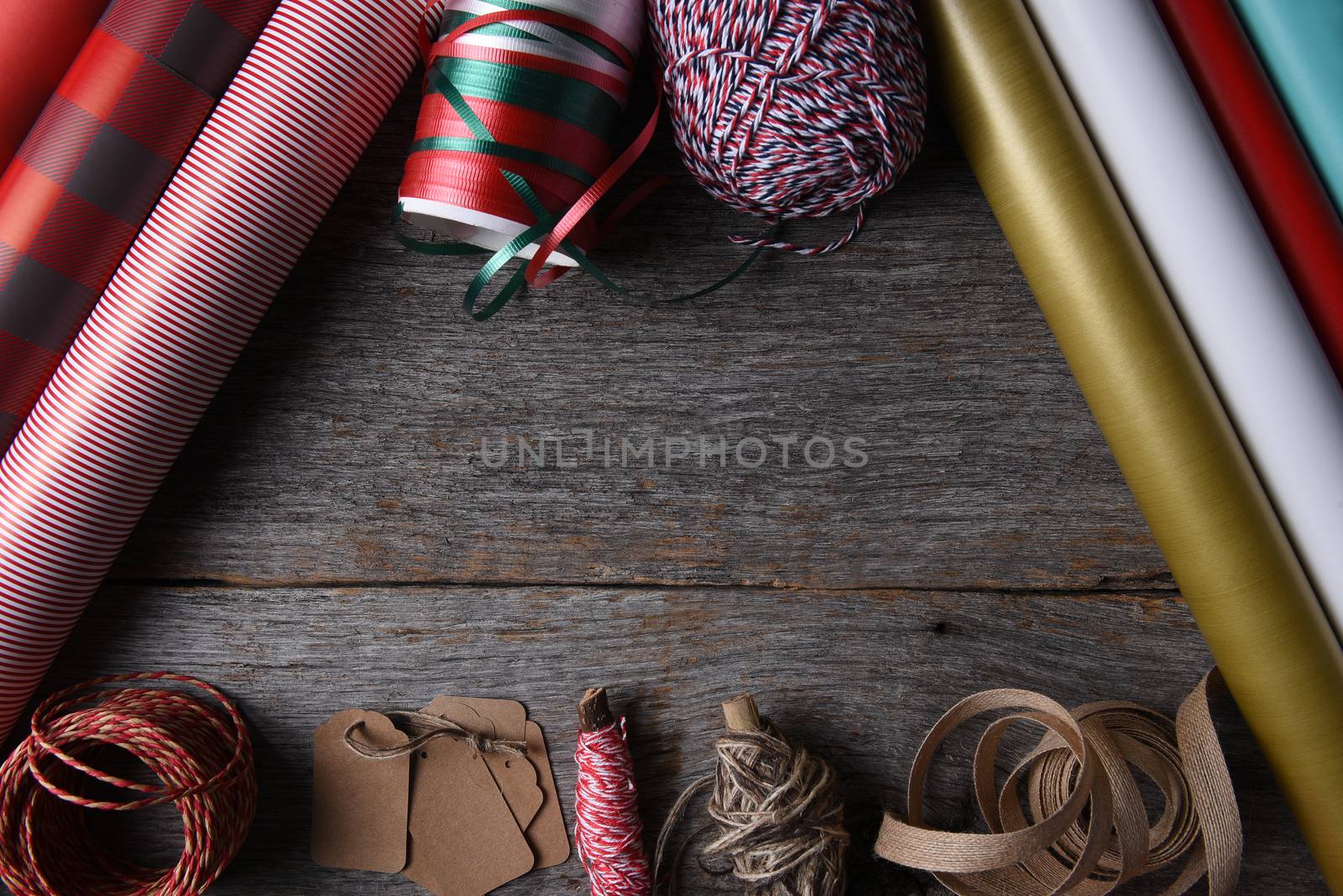 Top view of Christmas present wrapping supplies on a rustic wood table with copy space.