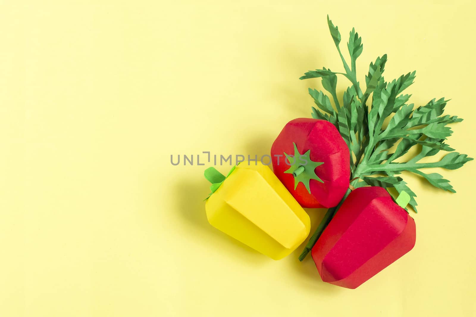 Colorful omato, pepper and parsley on yellow background. Real volumetric handmade paper objects. Paper art and craft