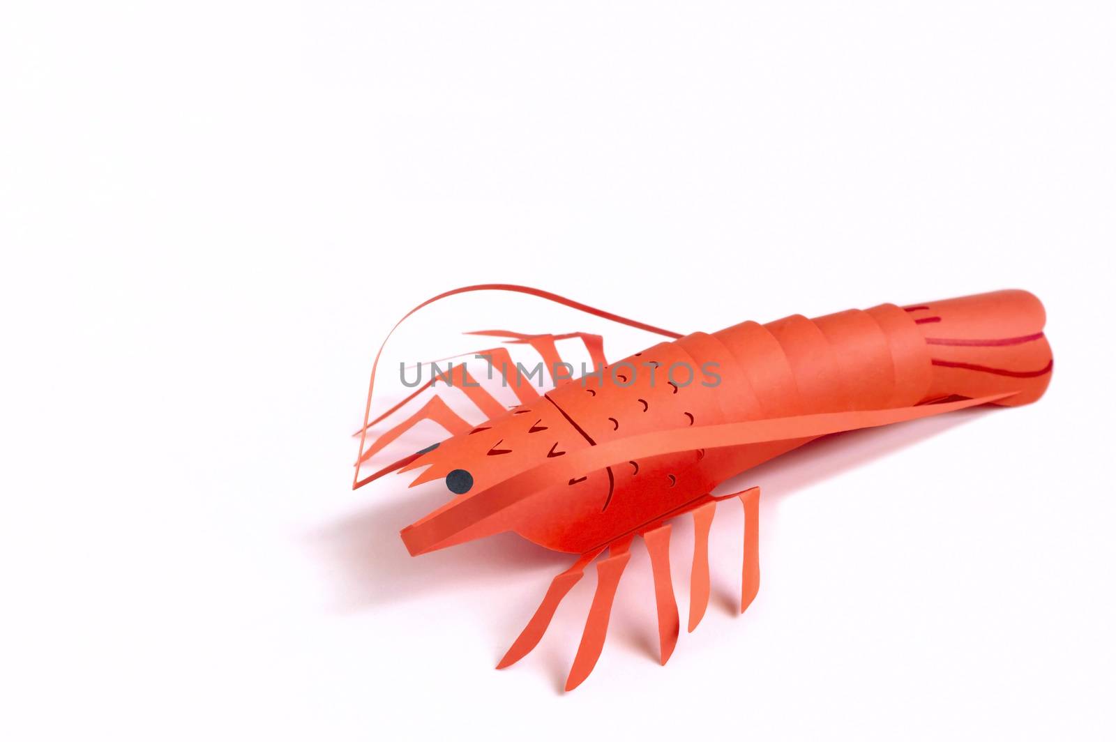 Paper lobster on peach color background. Real volumetric handmade paper objects. Paper art and craft