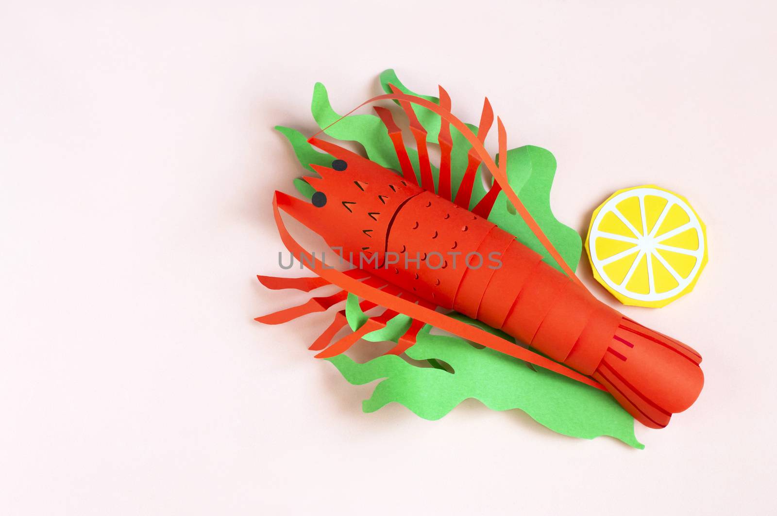 Paper lobster with lettuce and lemon slices. Real volumetric handmade paper objects. Paper art and craft