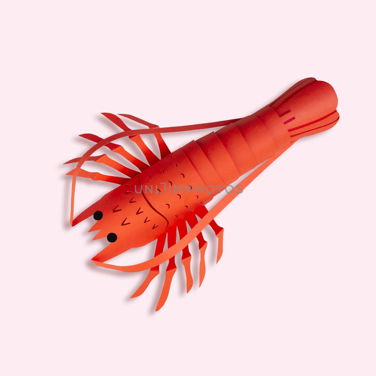 Paper lobster on peach color background. Real volumetric handmade paper objects. Paper art and craft