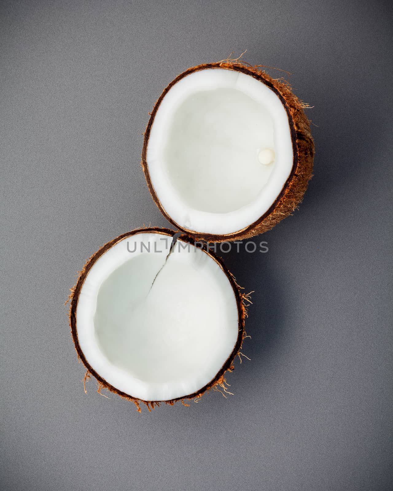 Whole of coconut shell on gray background flat lay and copy space. top view