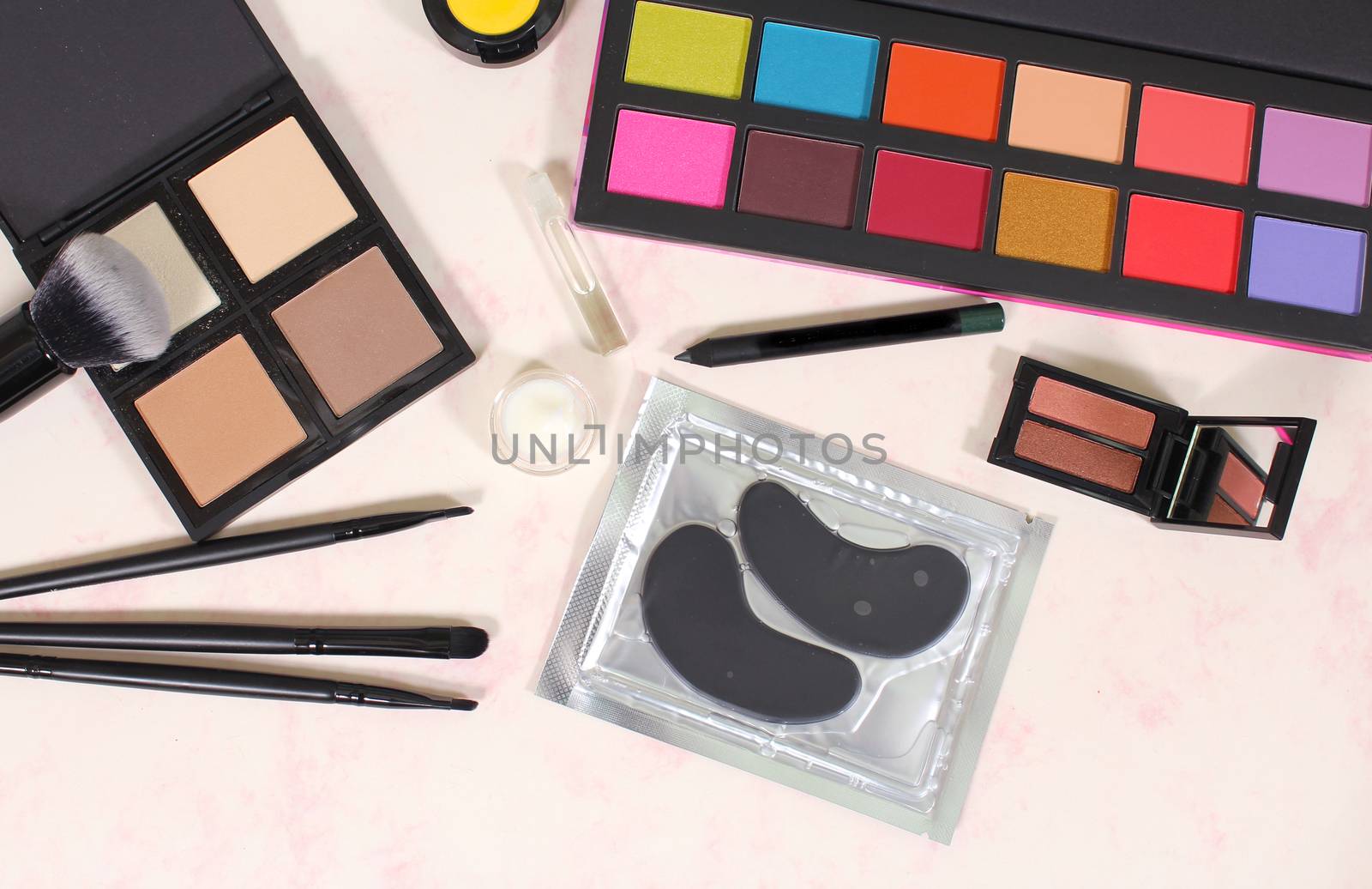 Various Cosmetics and Cosmetics Applicators on Paper Background