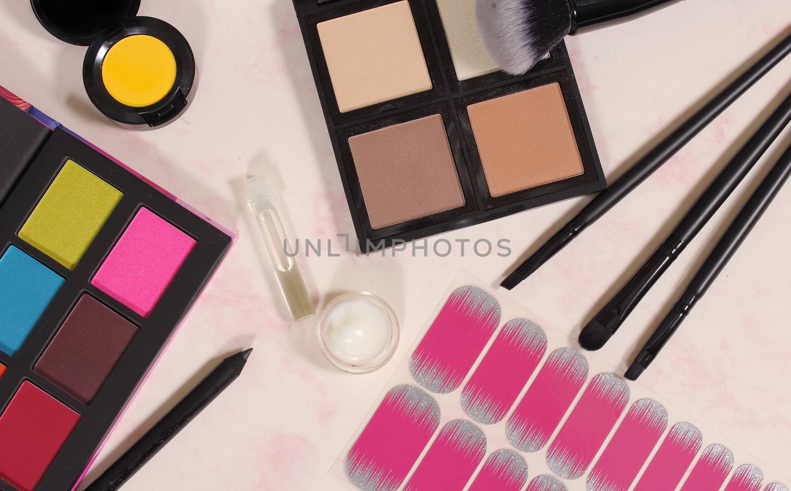 Various Cosmetics and Cosmetics Applicators on Paper Background