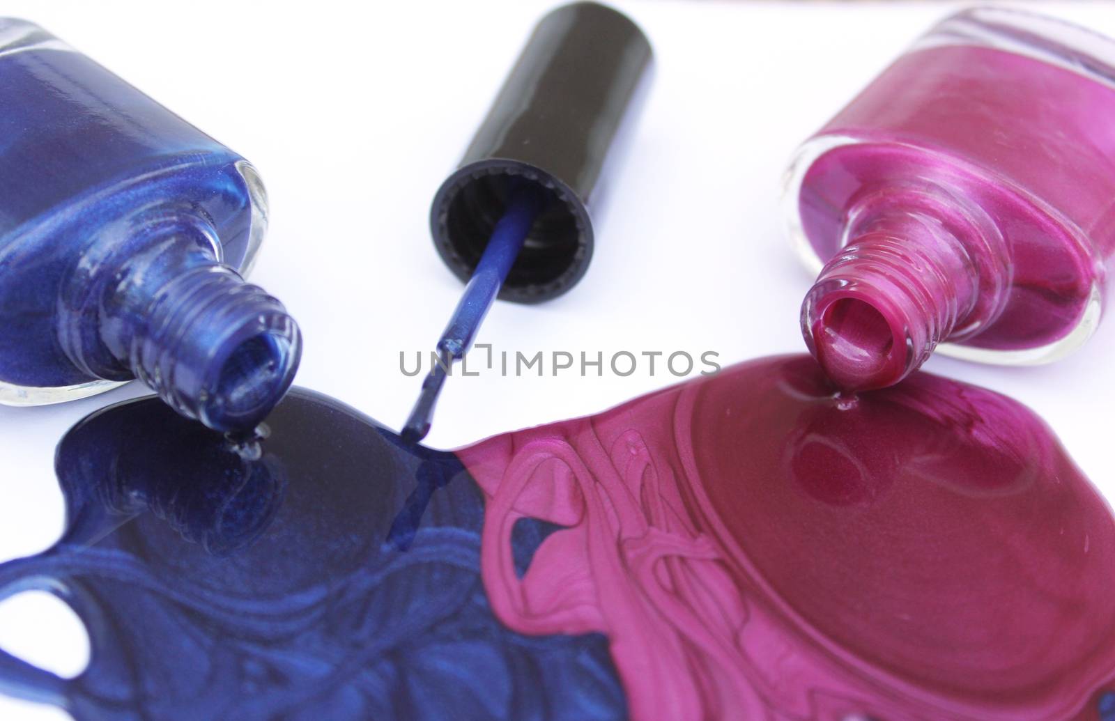Pink and Blue Spilled Nail Polish on White Background