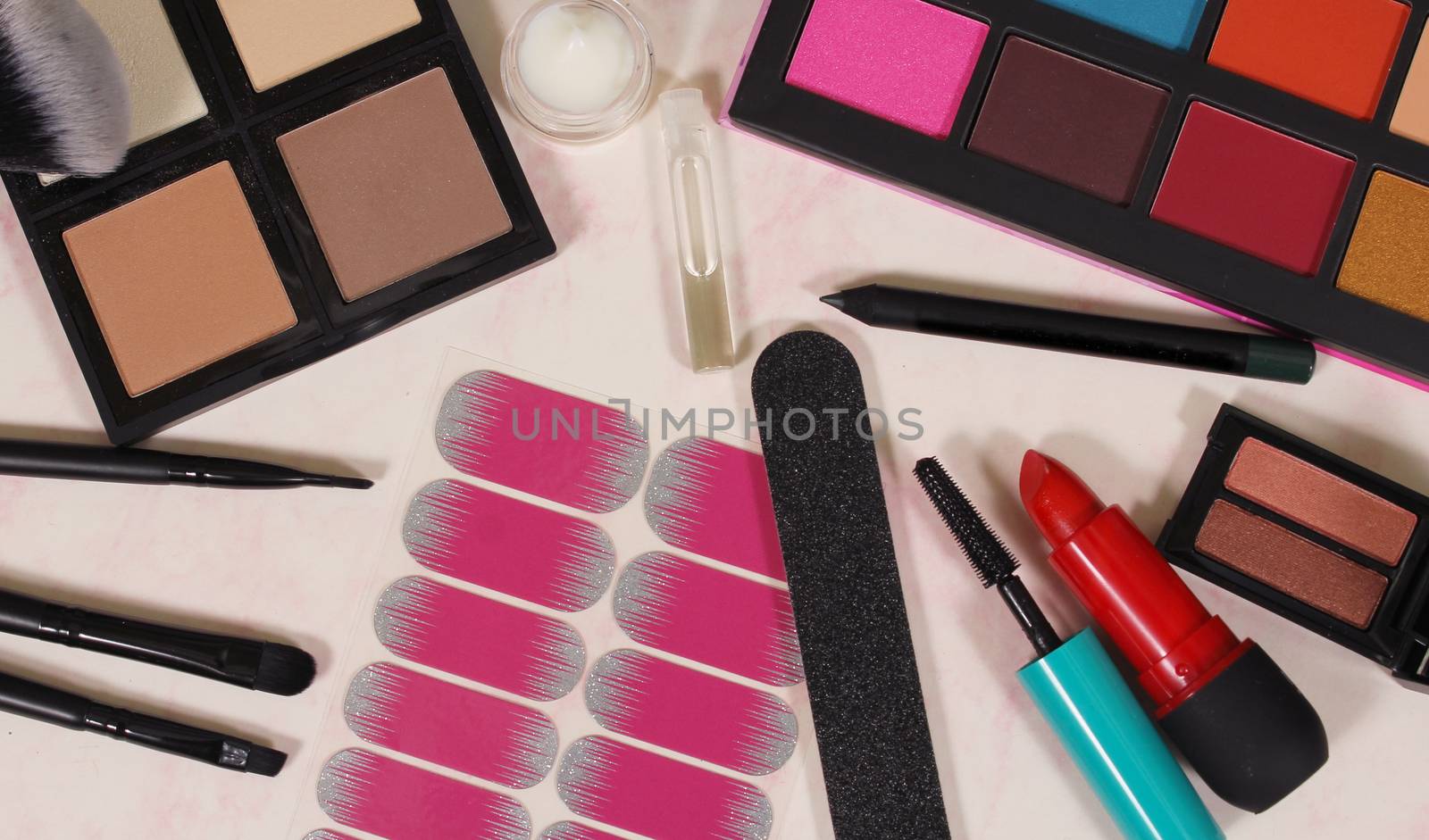 Various Colorful Cosmetics on paper background