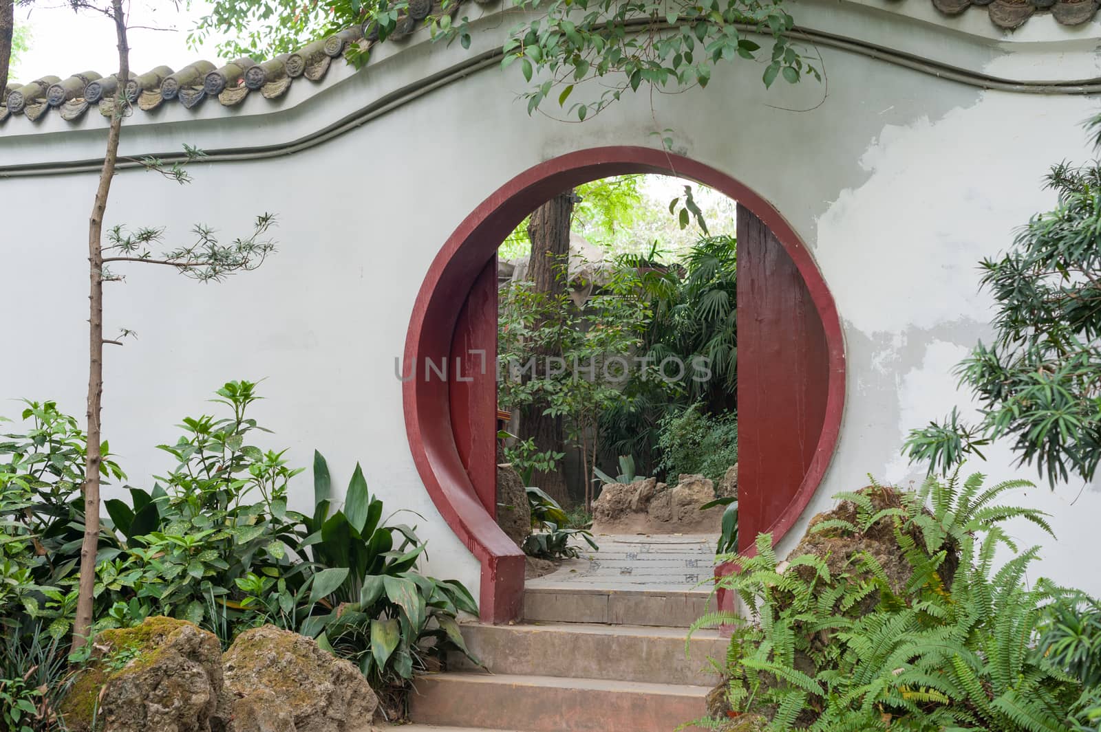 Chinese traditional circular door on a white wall in Culture park, Chengdu, China