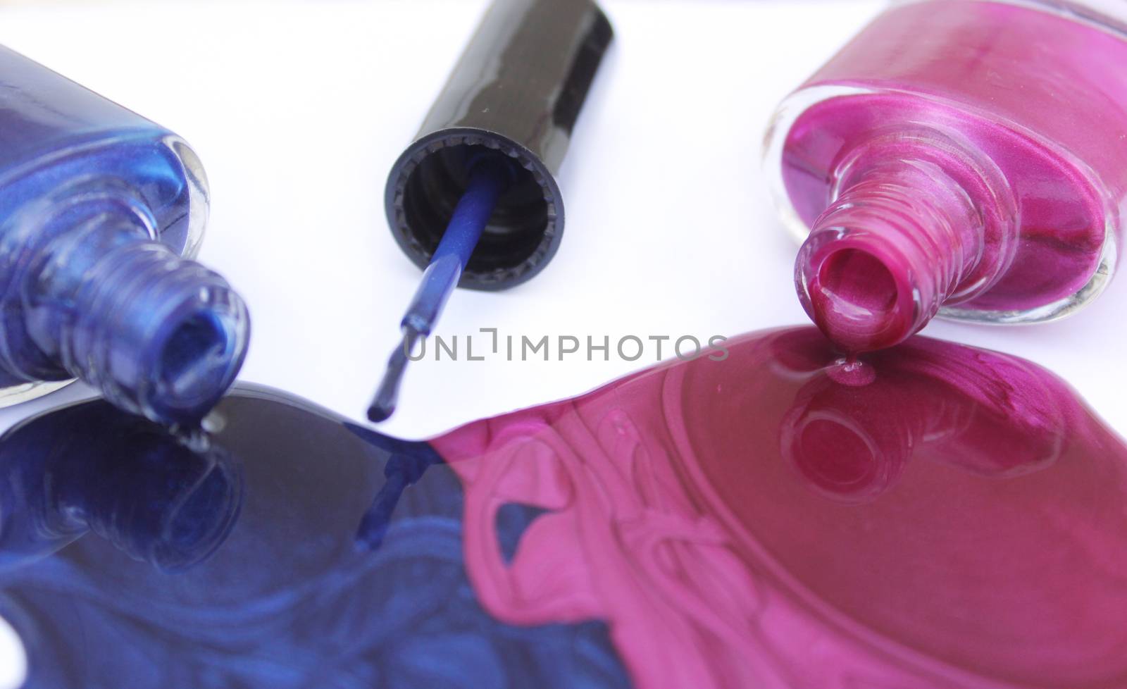 Pink and Blue Spilled Nail Polish on White Background