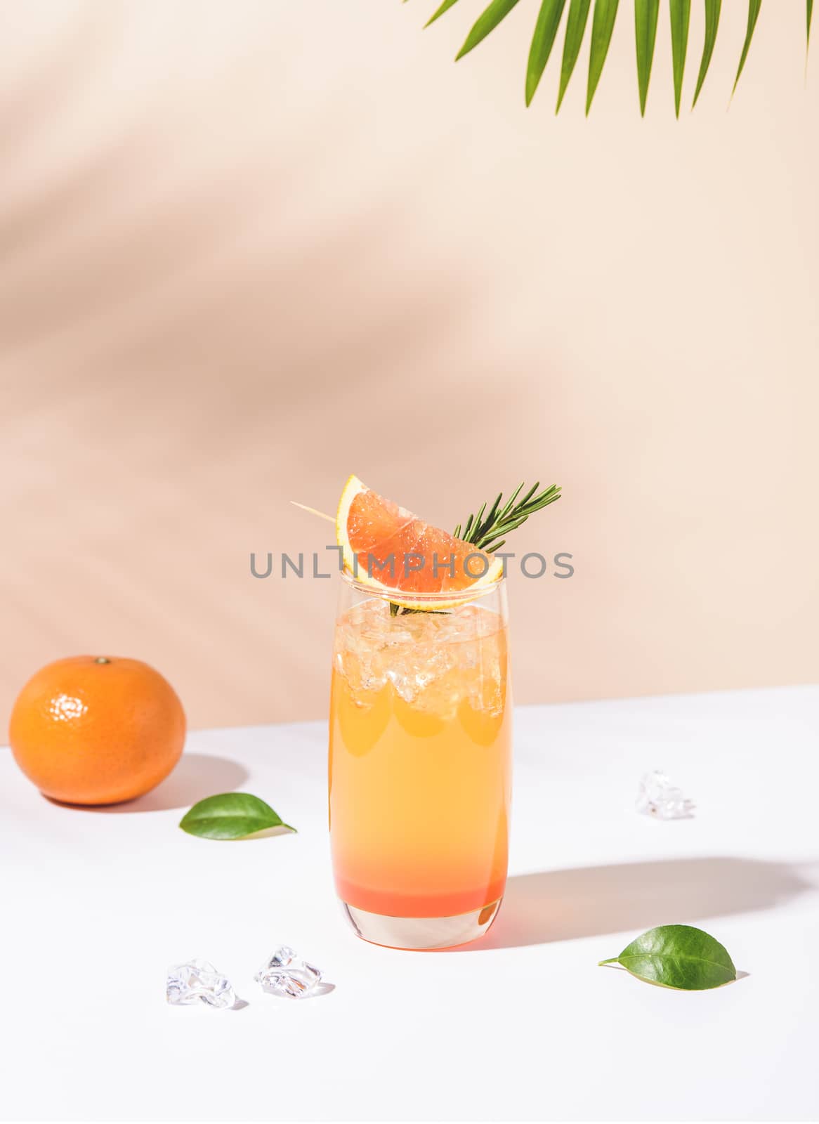 Cold and refreshing orange punch cocktail with orange slice on color background. summer drink.