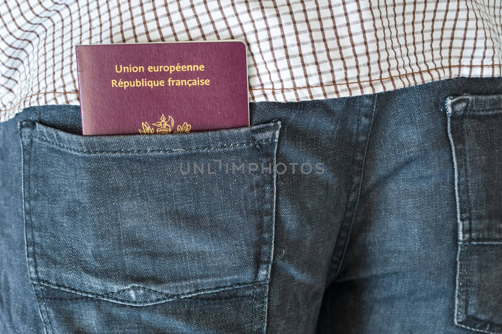 Man with a french passport in his blue jeans rear pocket