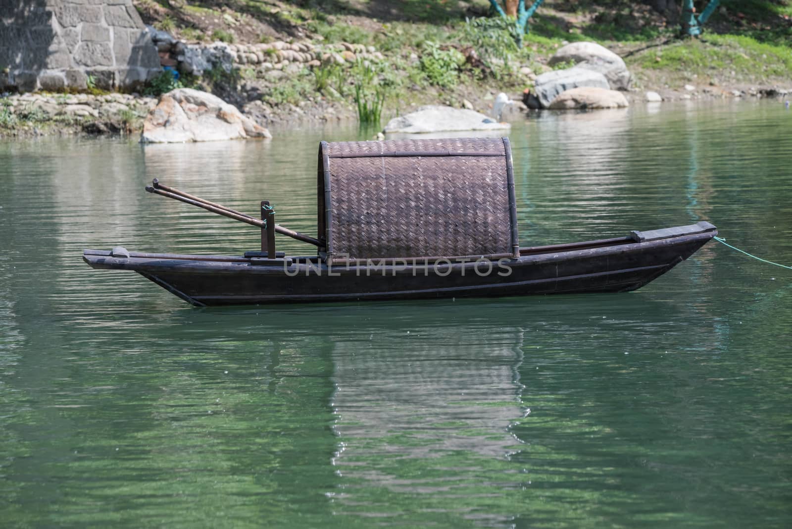 Chinese traditional fishing boat on a lake, HuanHuanXi park, Chengdu, China