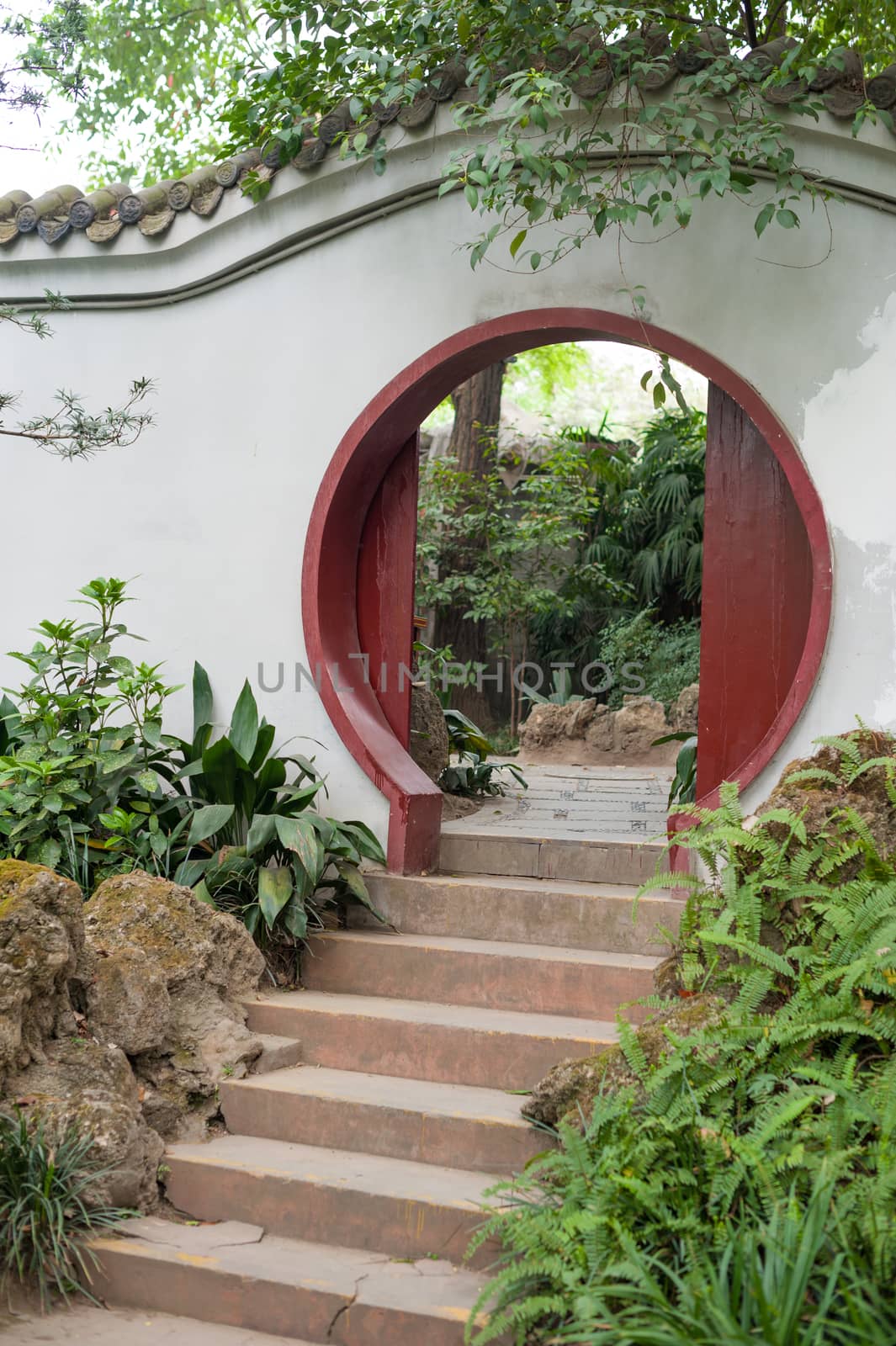 Chinese traditional circular door on a white wall in Culture park, Chengdu, China