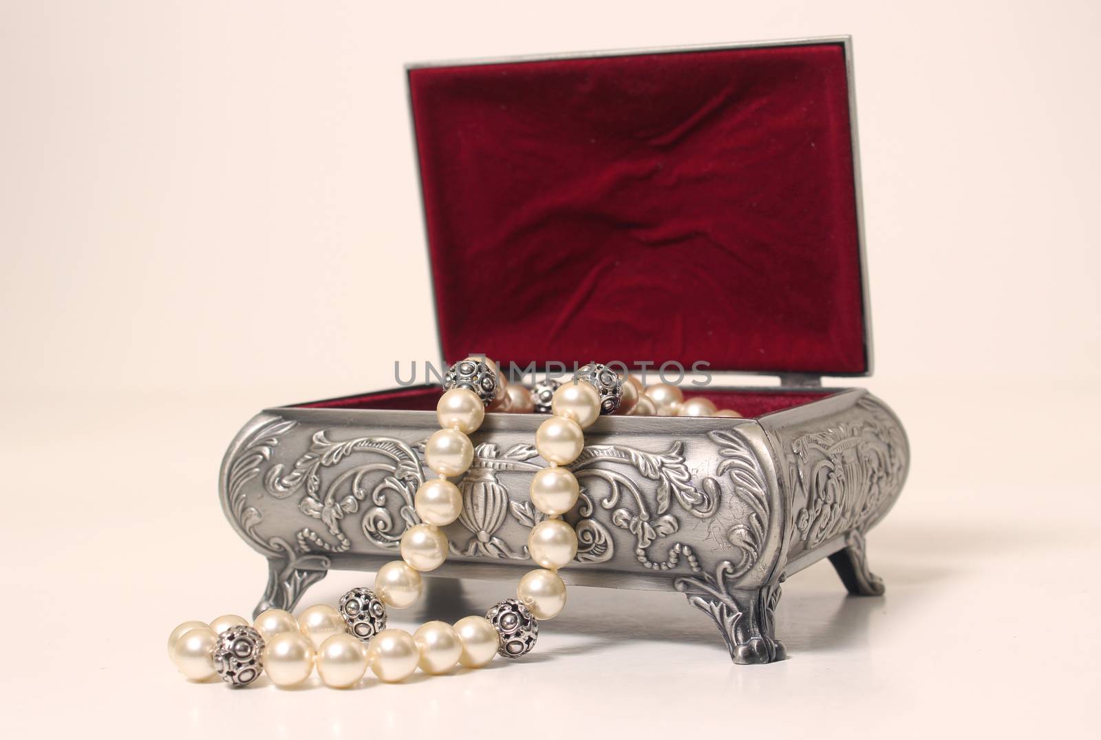 Jewelry Box With Pearl Necklace on light background by Marti157900