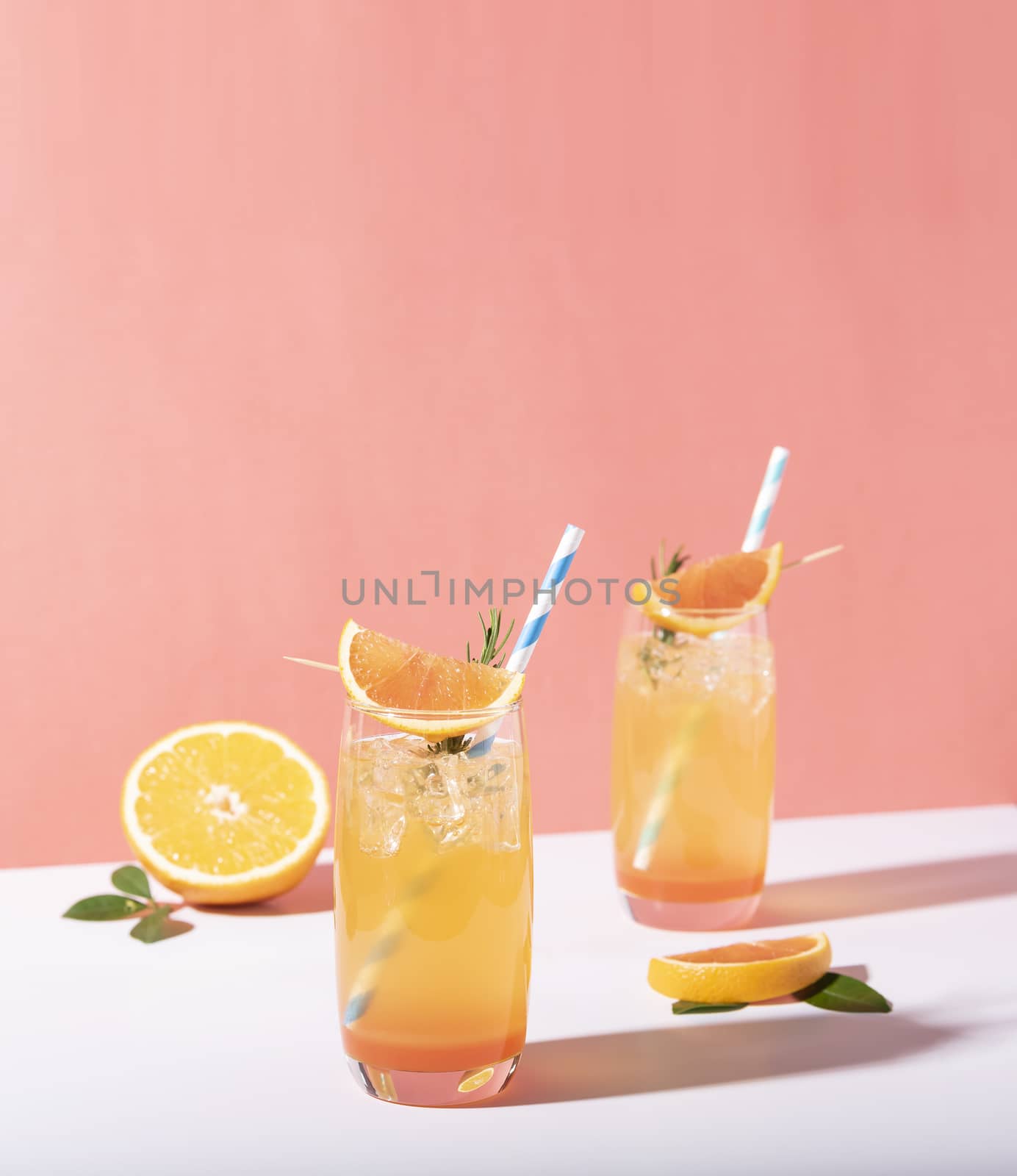 Cold and refreshing orange punch cocktail with orange slice on color background. summer drink.