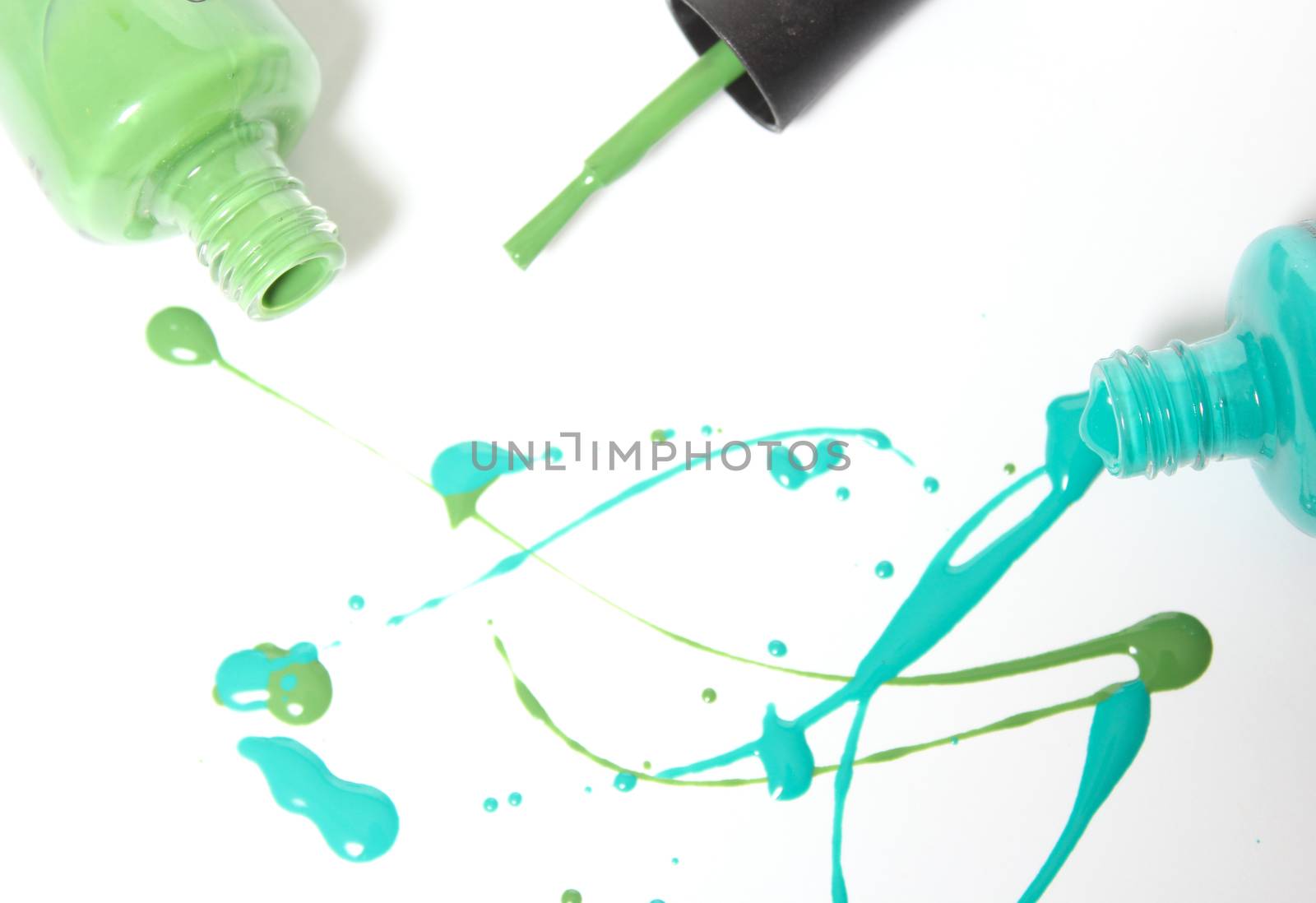 Blue and Green Spilled Nail Polish on White Background