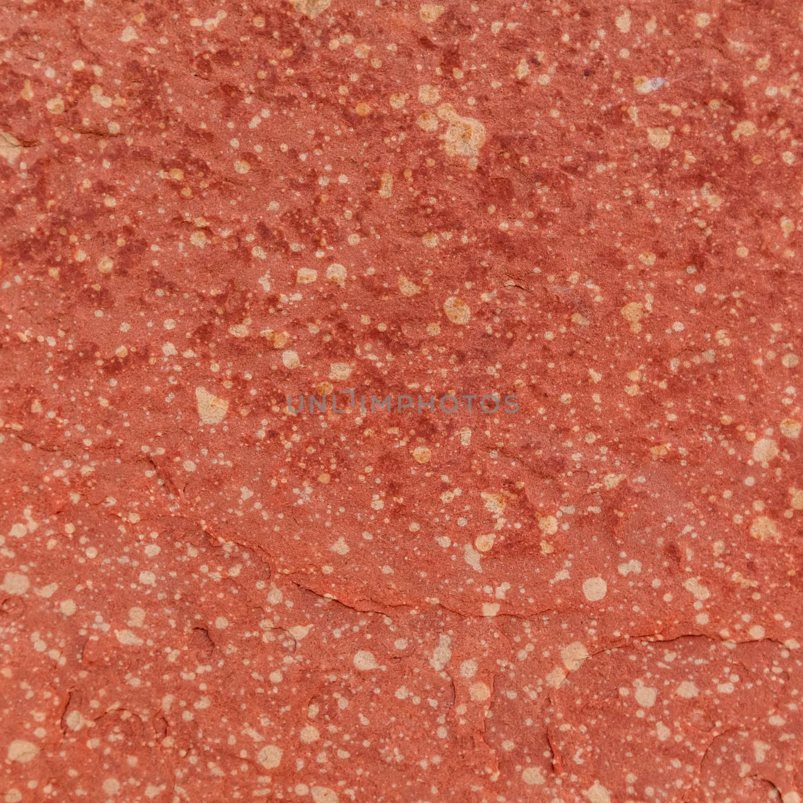 Red rough stone texture background. Material construction and architectural detail.