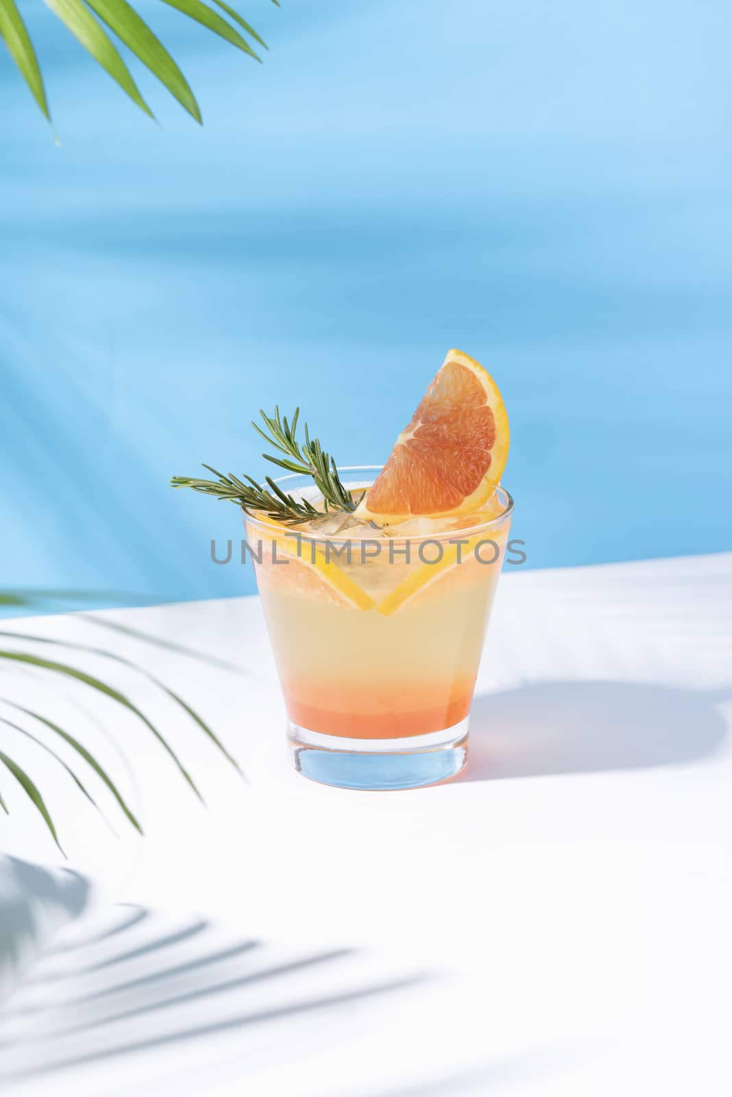 Cold and refreshing orange punch cocktail with orange slice on color background. summer drink.