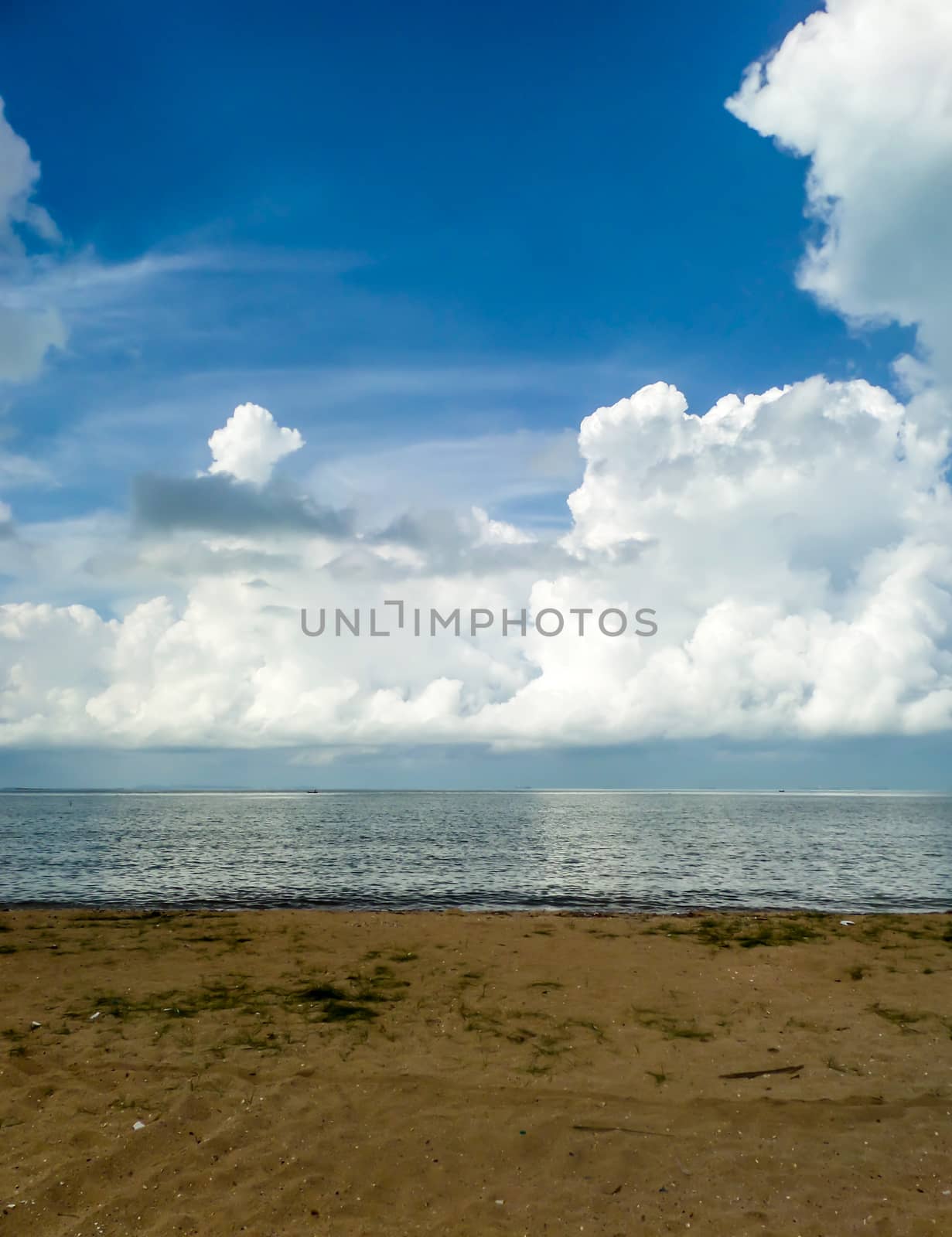 White cloud and the blue sky and sea sand beach