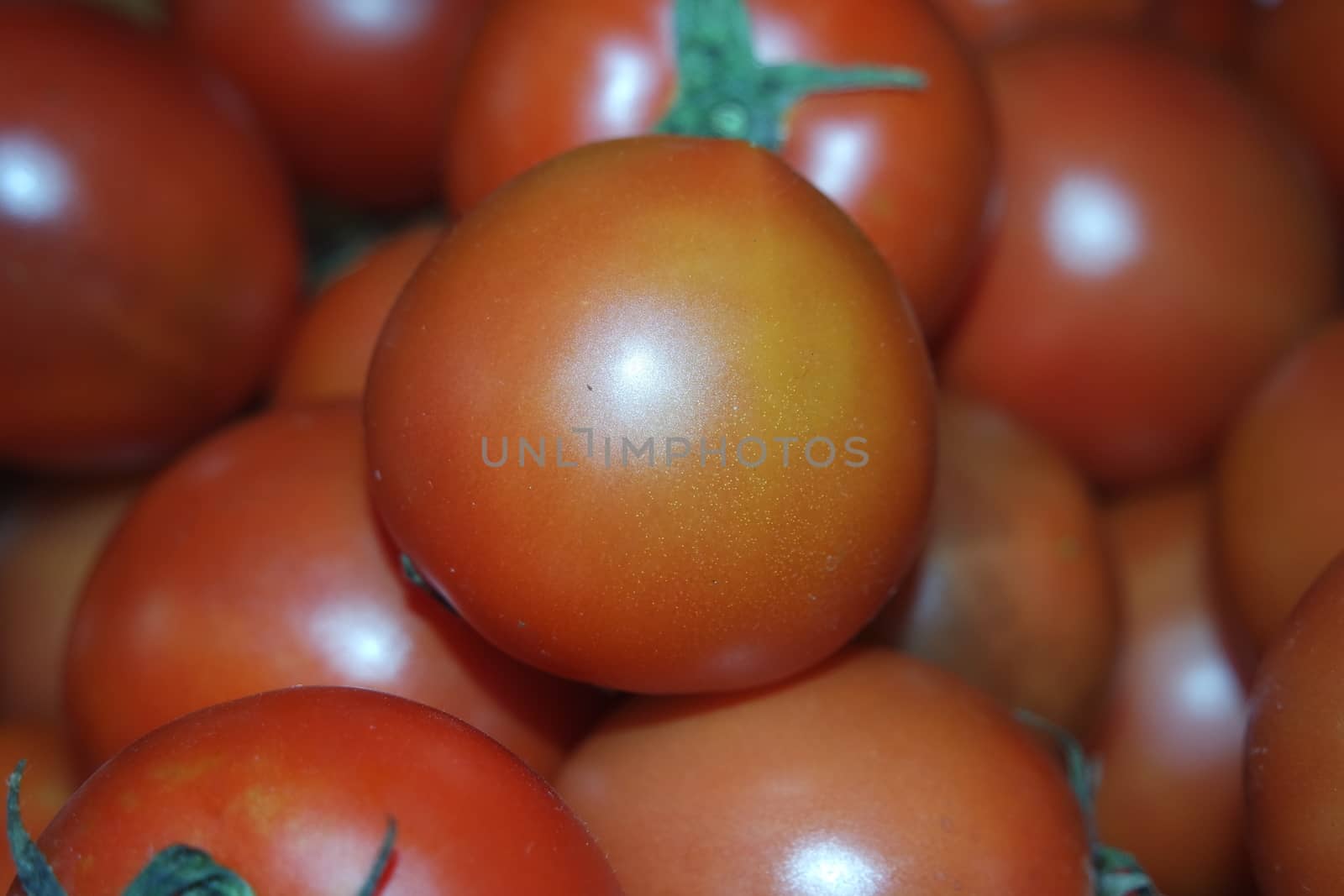 Close-up view of red tomatoes in market for sale. A fruit background for text and advertisements