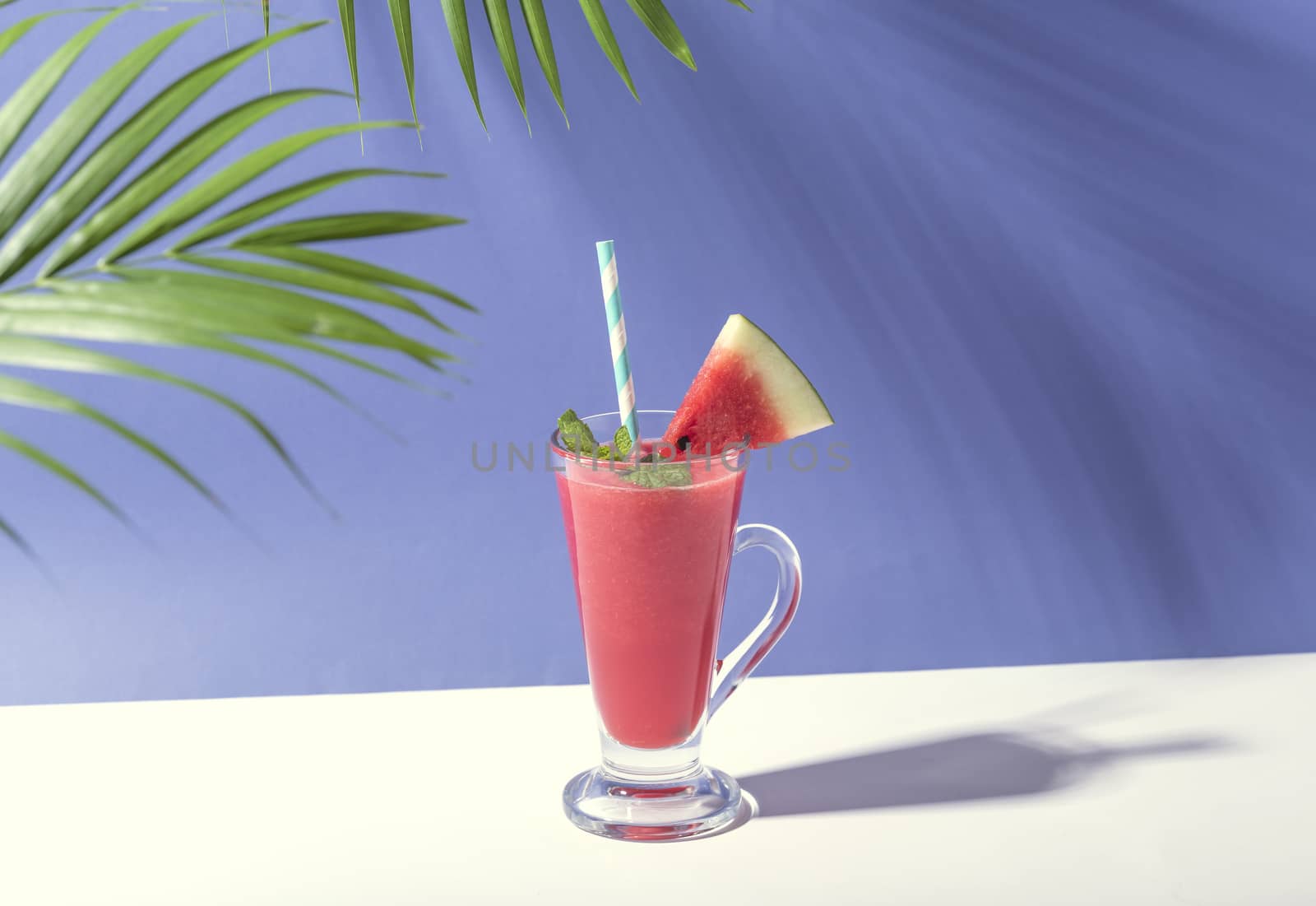 Fresh water melon juice and watermelon slice on color background. summer drink.