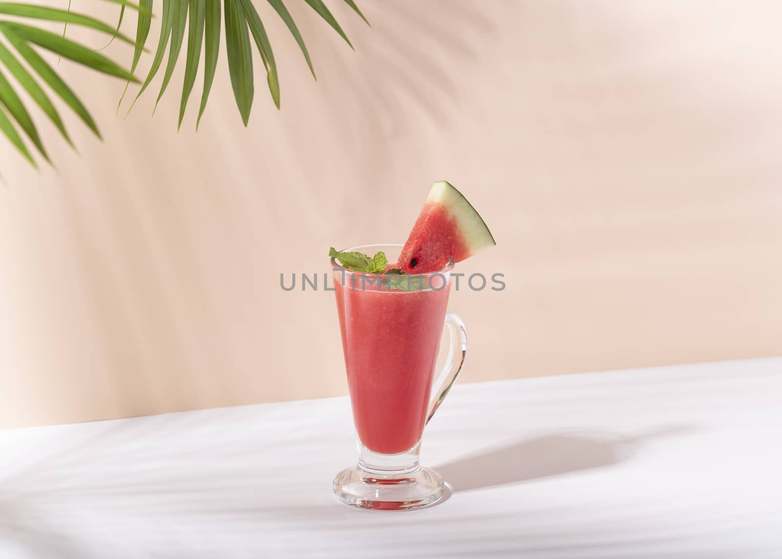 Fresh water melon juice and watermelon slice on color background. summer drink.