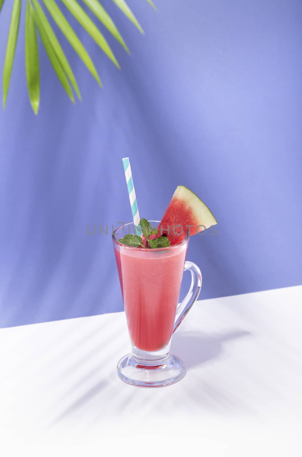 Fresh water melon juice and watermelon slice on color background. summer drink.